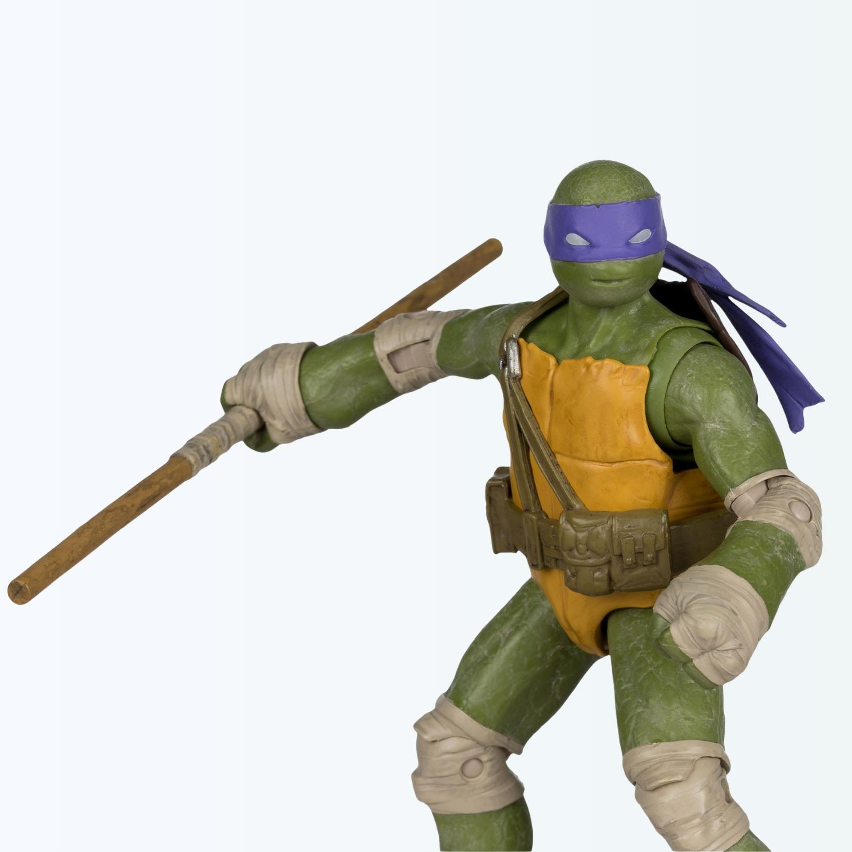 Dynamic angle shot of Donatello action figure leaning forward with bo staff raised