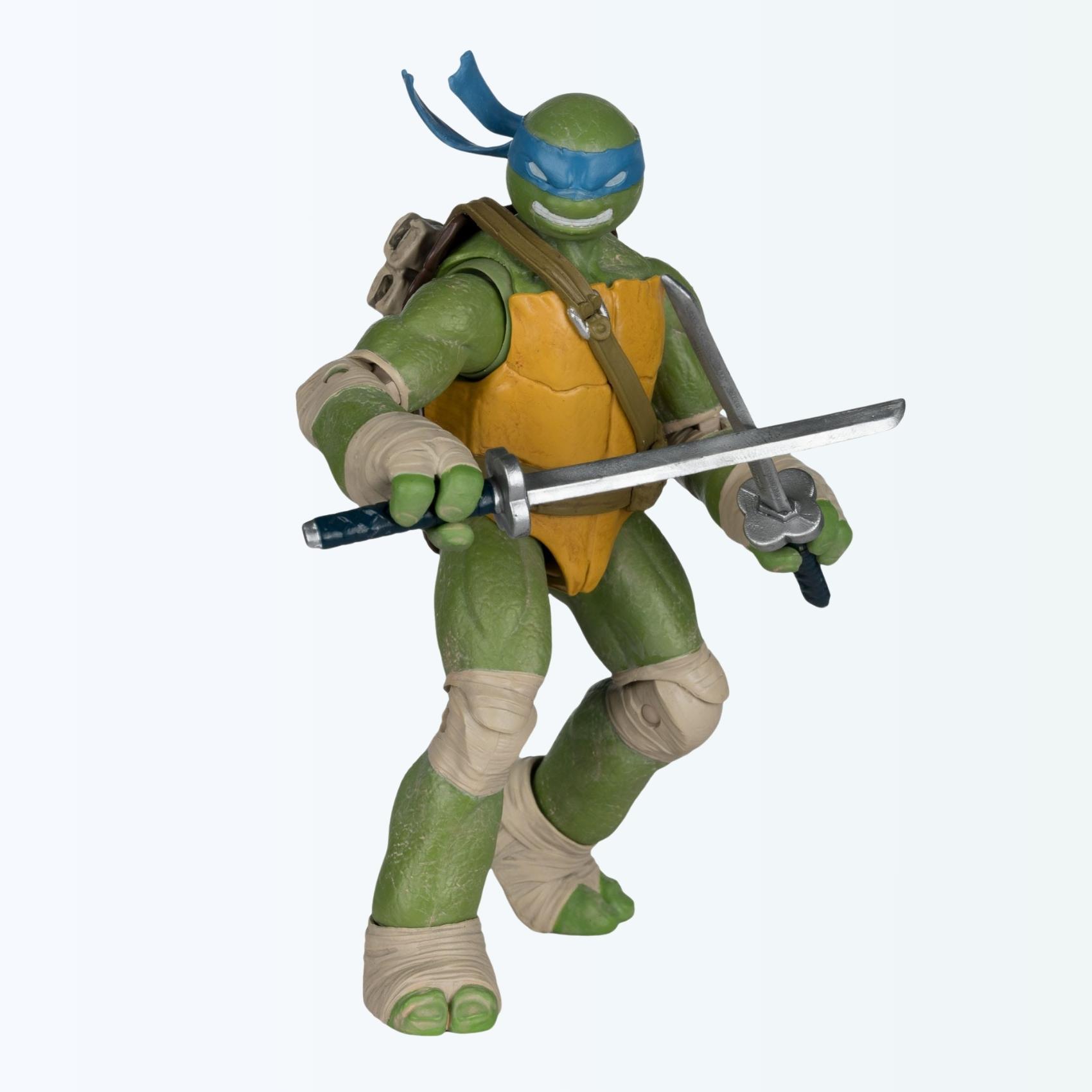 Angled dynamic shot of Leonardo action figure holding both katanas in a battle ready stance