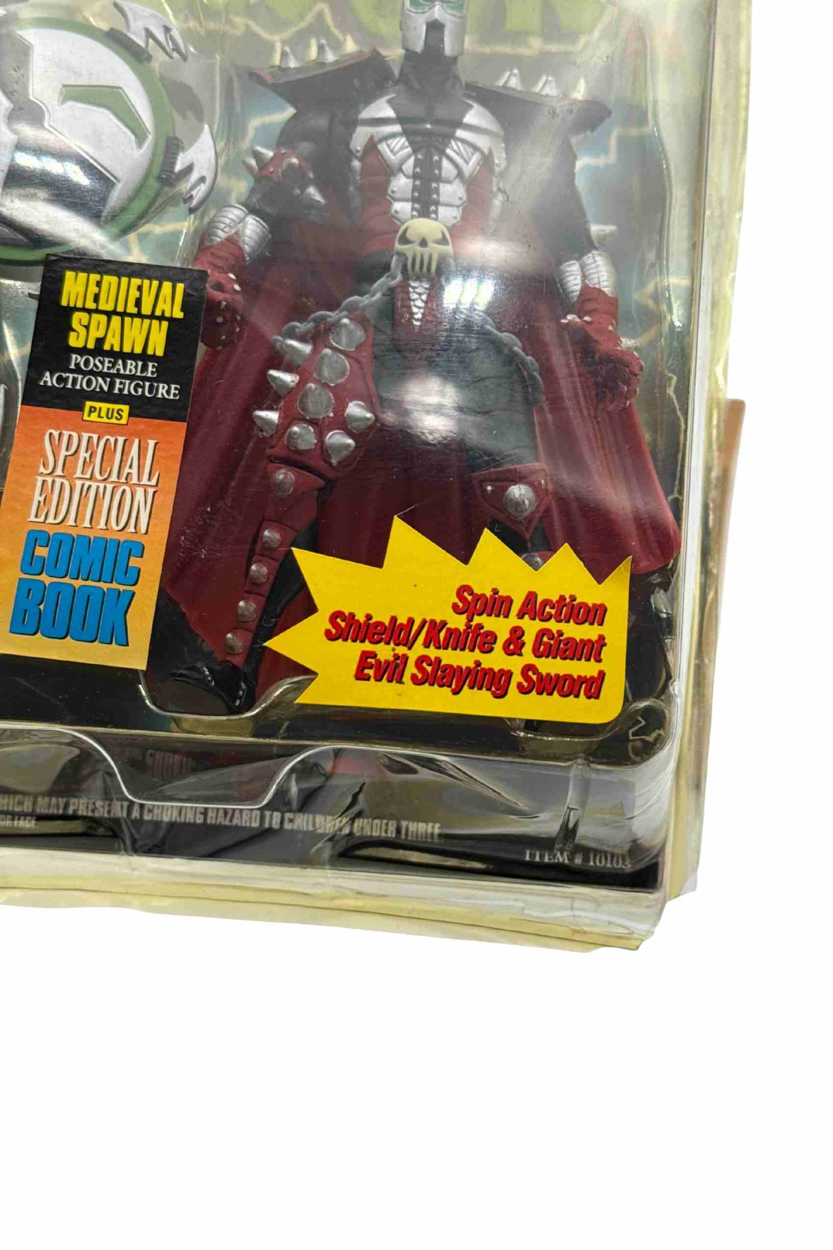 Close-up shot of Medieval Spawn action figure showing damage to bottom right blister packaging corner