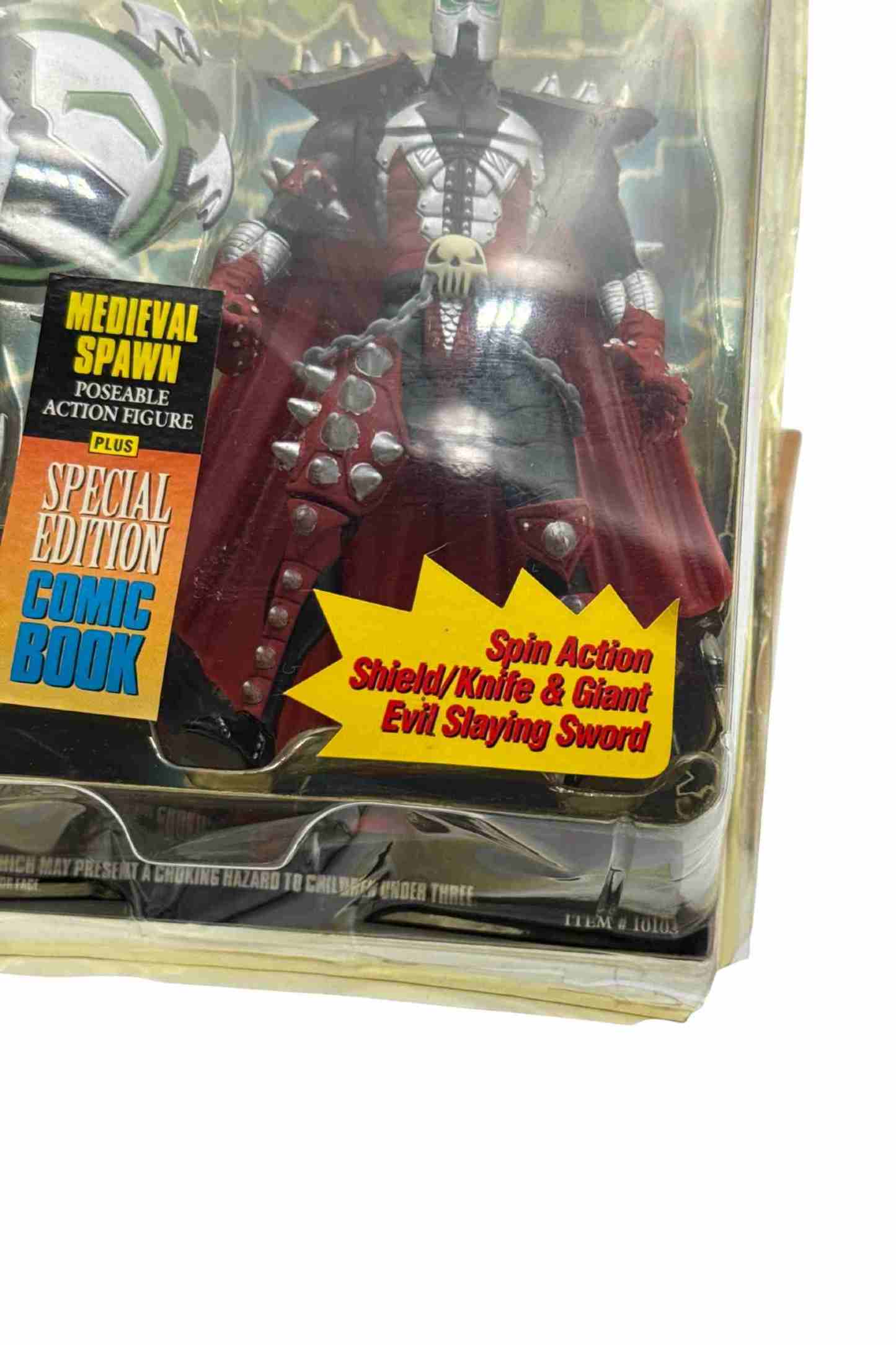 Close-up shot of Medieval Spawn action figure showing damage to bottom right blister packaging corner