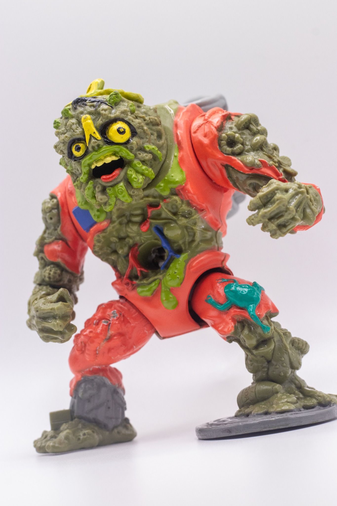 Dynamic front-angled pose of TMNT Muckman action figure with open mouth and raised fist