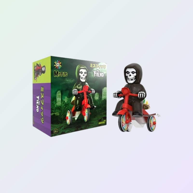 Boxed and unboxed Misfits The Fiend figure on red trike with rainbow wheel detailing and Japanese-style packaging