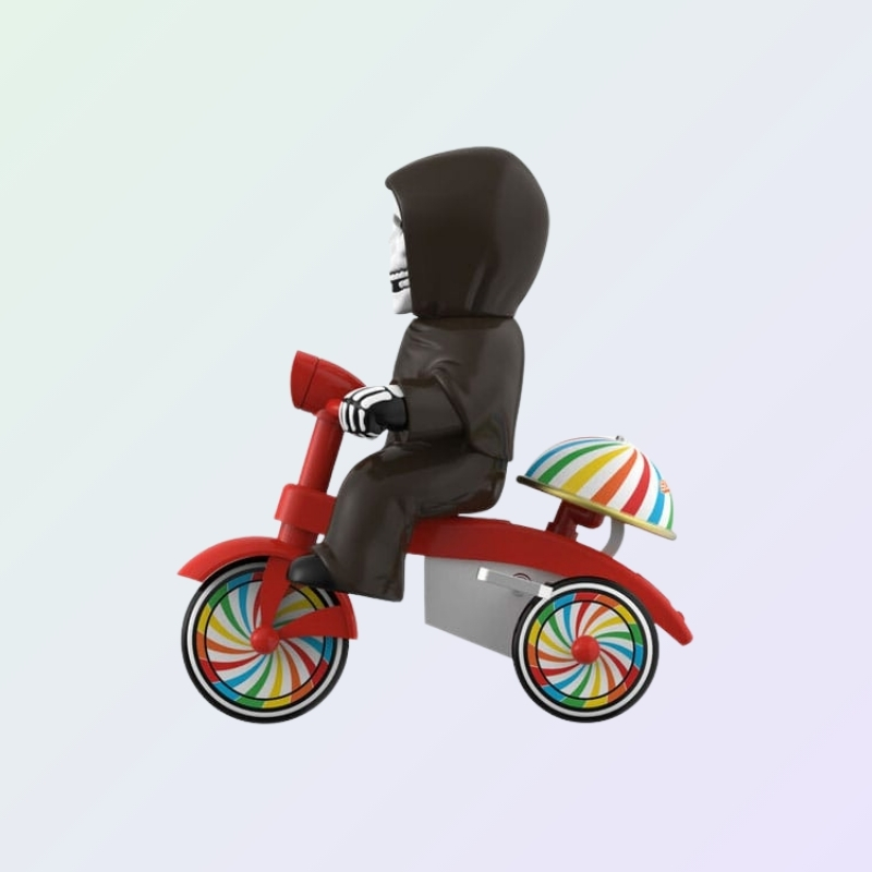 Side profile of Misfits The Fiend figure on tricycle with umbrella-striped dome over rear wheels