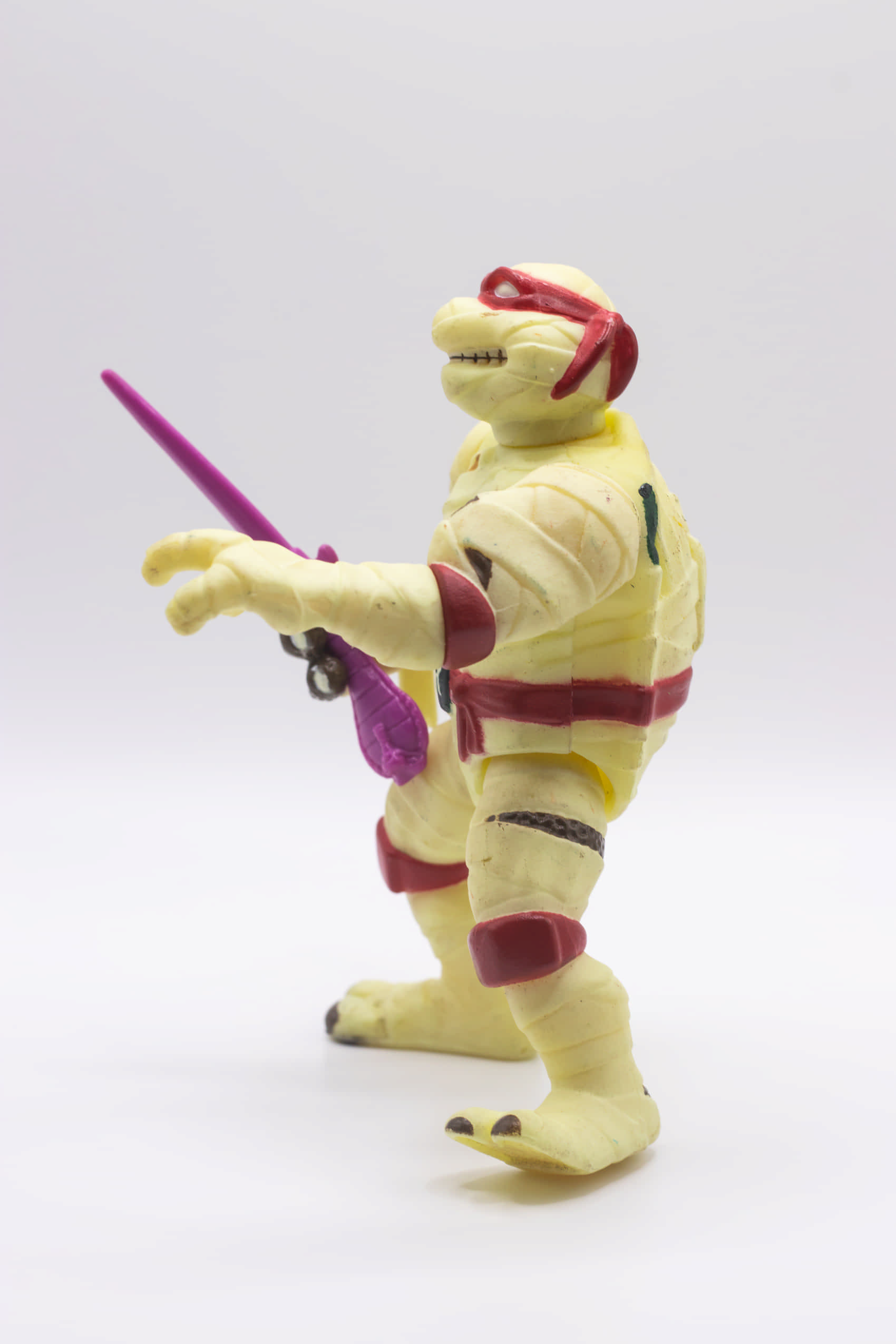 Left side view of vintage Mummy Raph action figure holding a single Cobra Sai