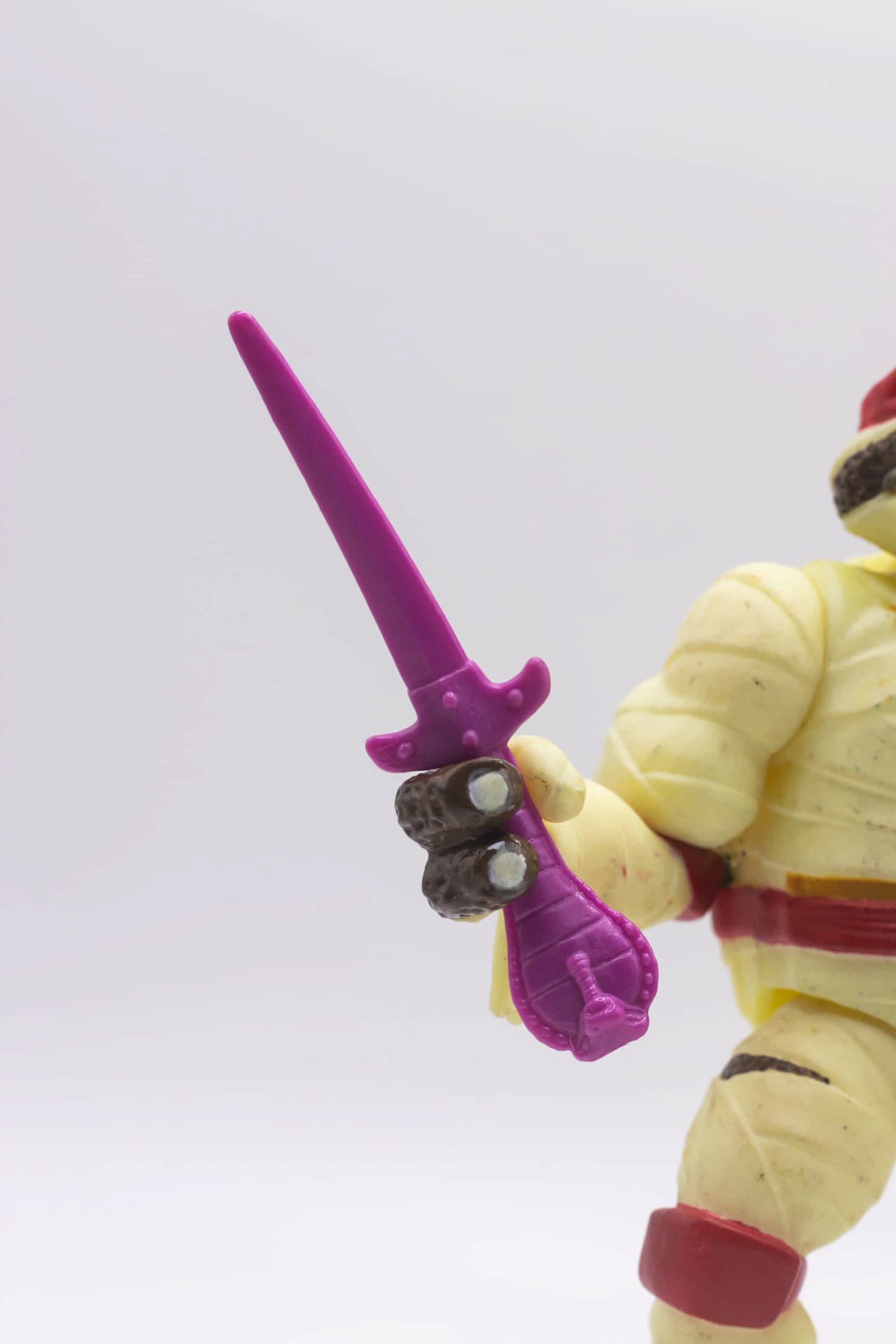 Close-up of Mummy Raph's hand holding the Cobra Sai accessory