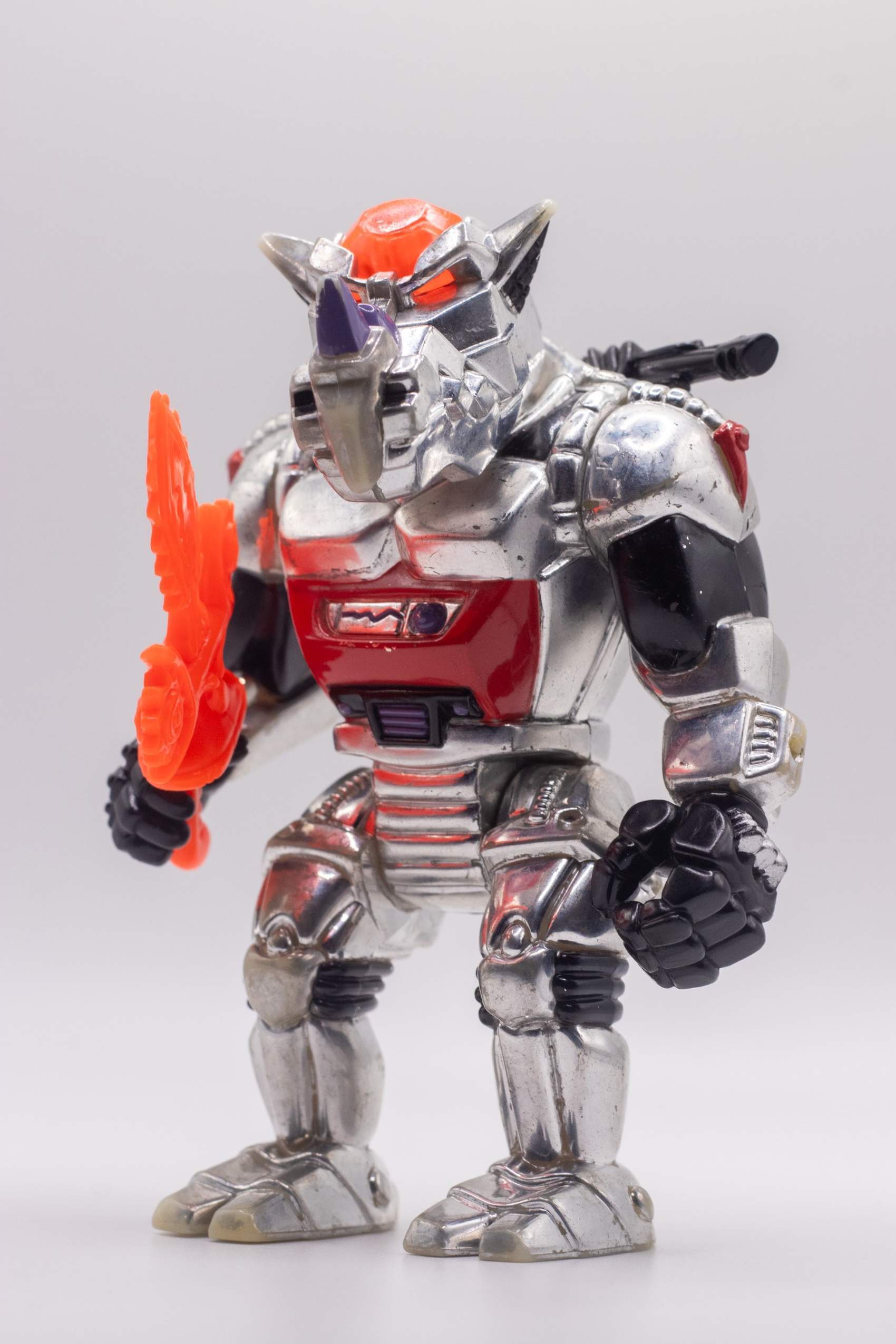 Front-facing shot of Robotic Rocksteady action figure holding Chilling Chainsaw Sword in right hand