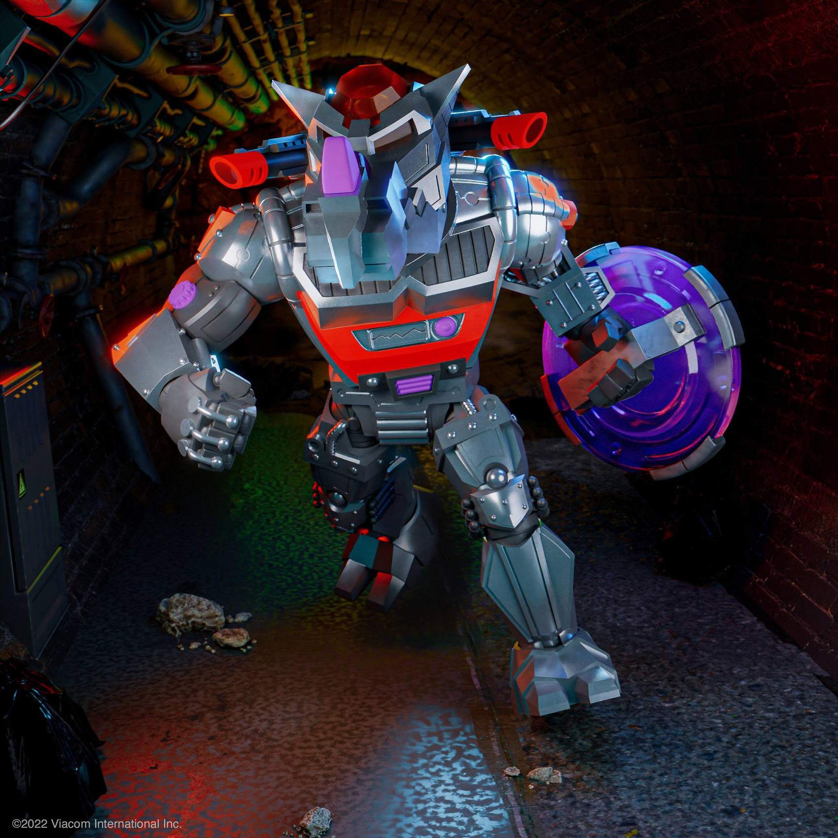 Front pose of Robotic Rocksteady action figure charging through sewer with purple shield