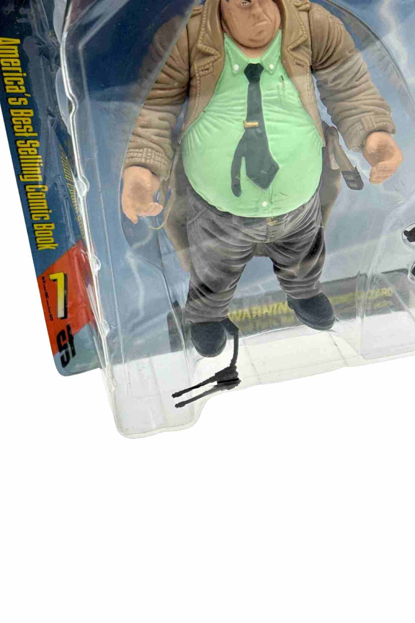 Low angle close-up of Sam action figure inside blister showing loose radio headset accessory
