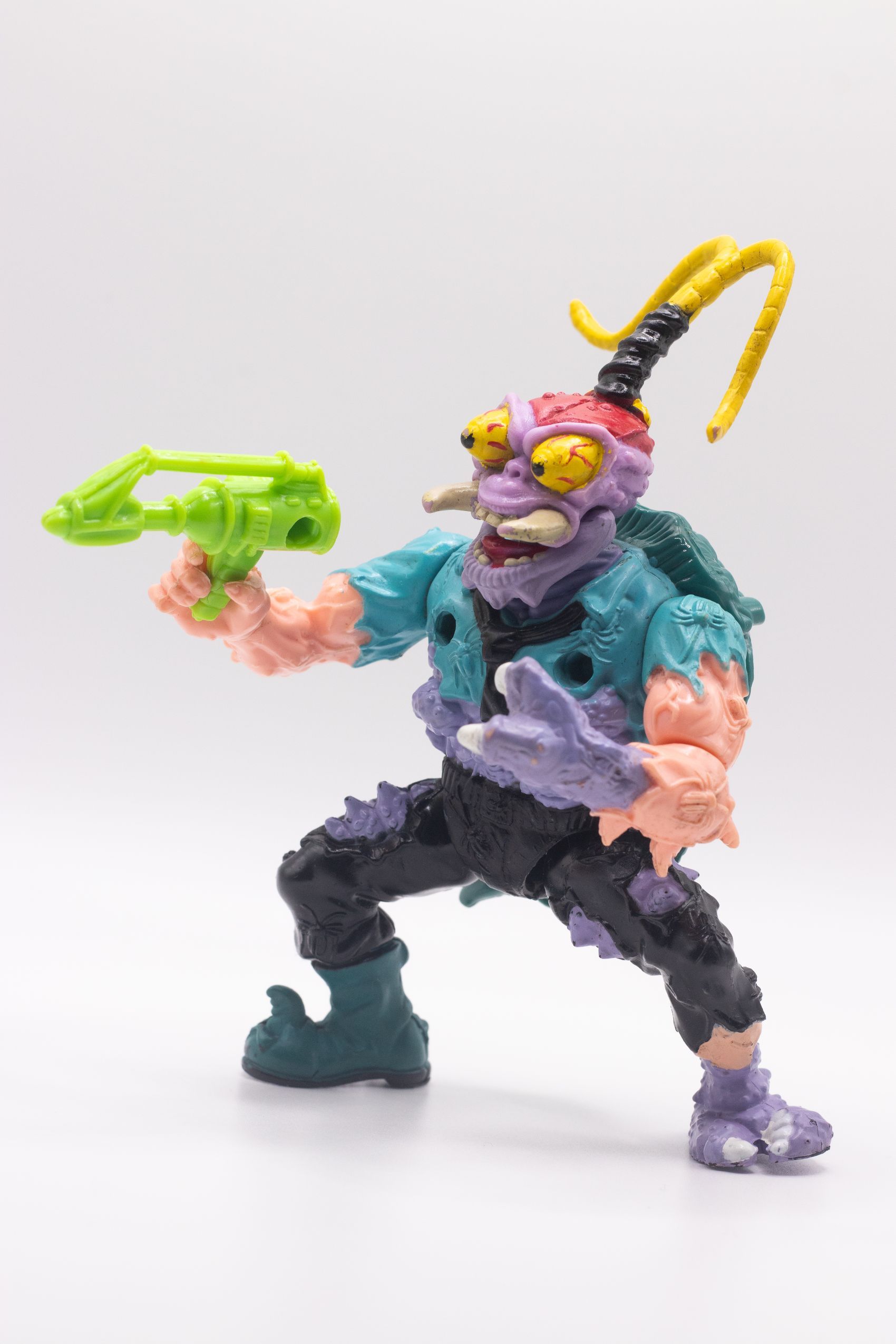 Left-angled shot of Scumbug action figure aiming Turtle Exterminating Gun