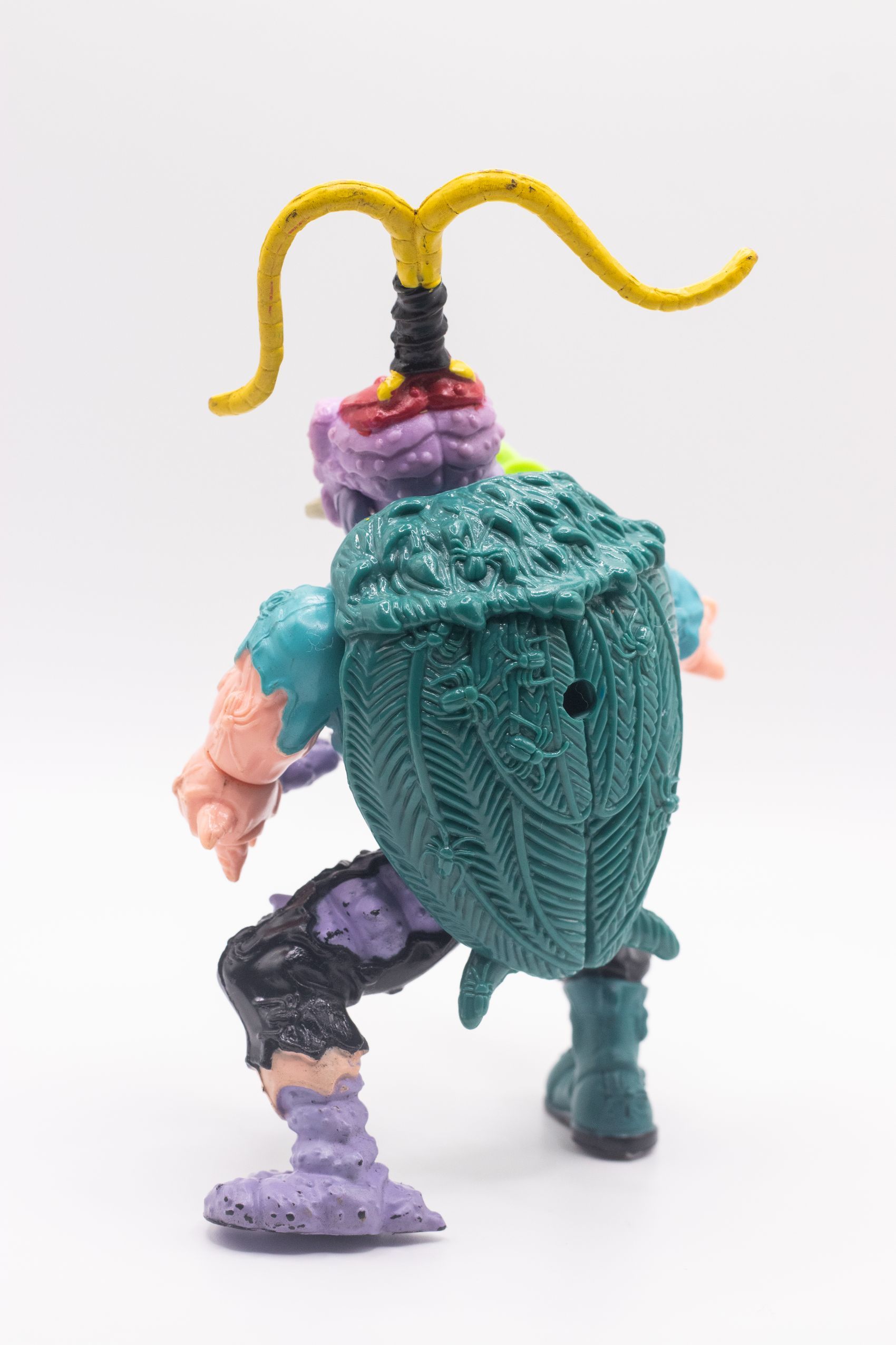 Rear view of Scumbug action figure with sculpted shell and bug details