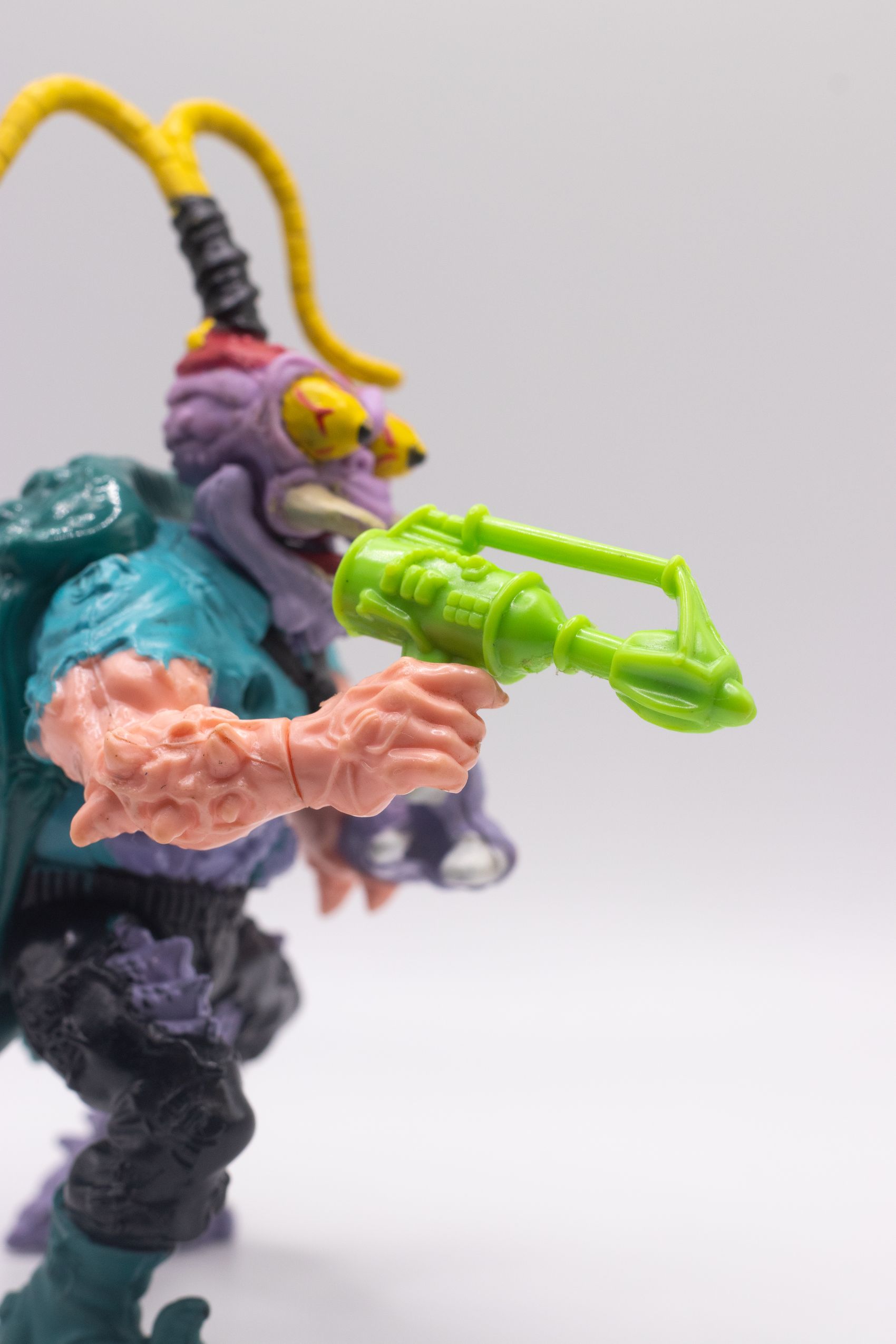 Close-up of Scumbug action figure holding Turtle Exterminating Gun accessory