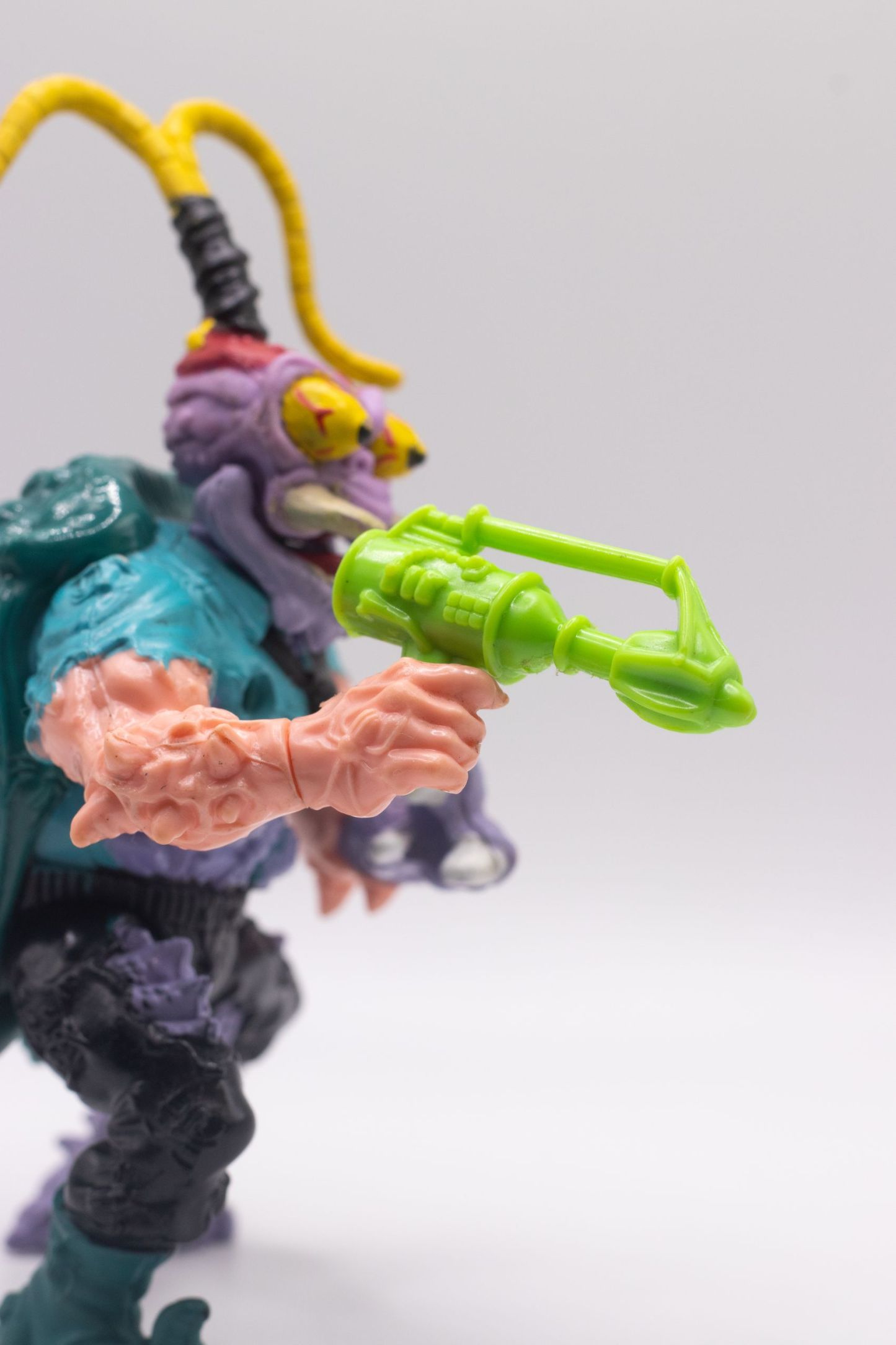 Close-up of Scumbug action figure holding Turtle Exterminating Gun accessory