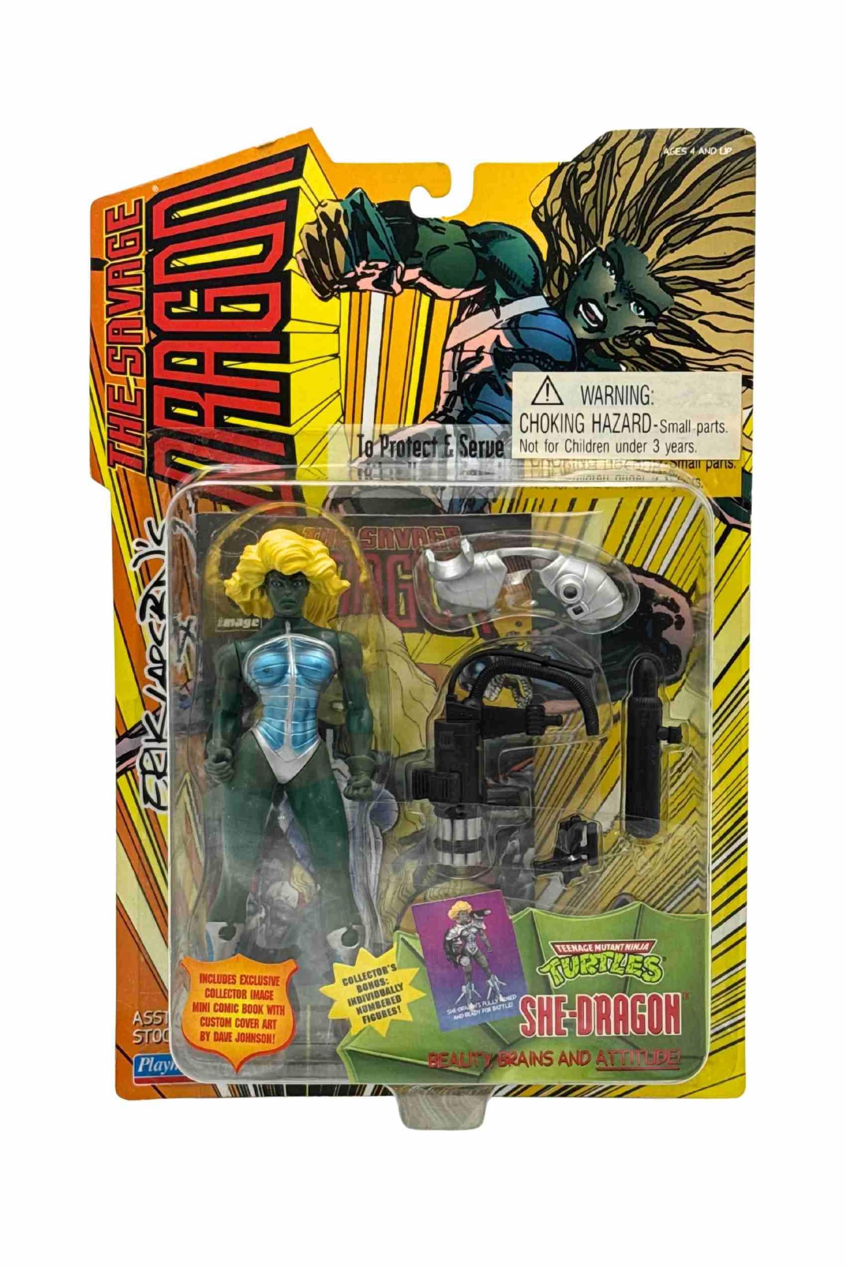 Front carded shot of She-Dragon action figure with long blonde hair, green skin and metallic blue armour with rocketboot harness and weapon accessories in clear blister packaging