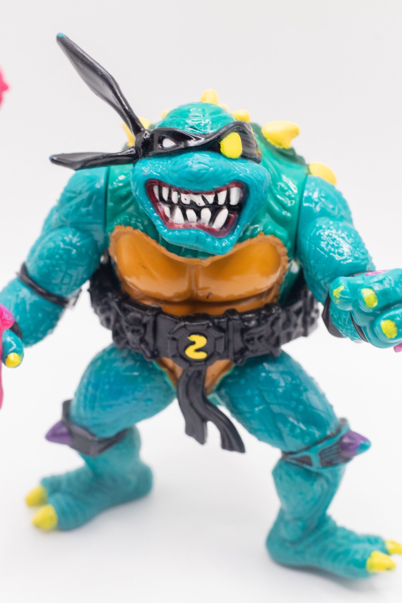 Dynamic front-angled pose of TMNT Slash action figure showing teeth and raised claw