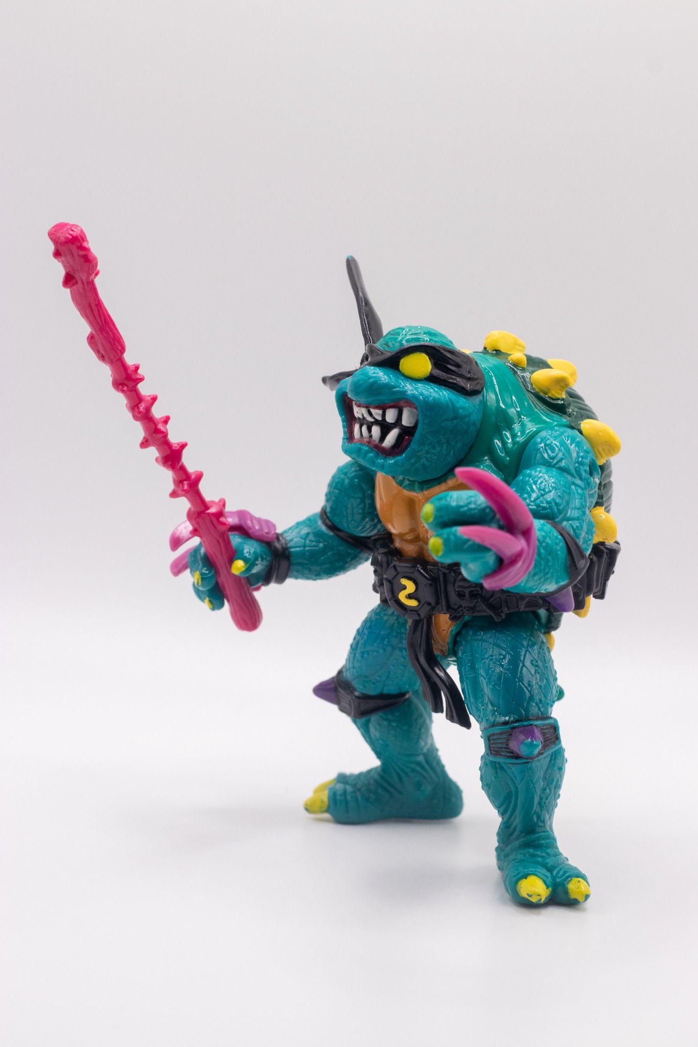 Left side profile of TMNT Slash action figure holding Nasty Nunchaku accessory
