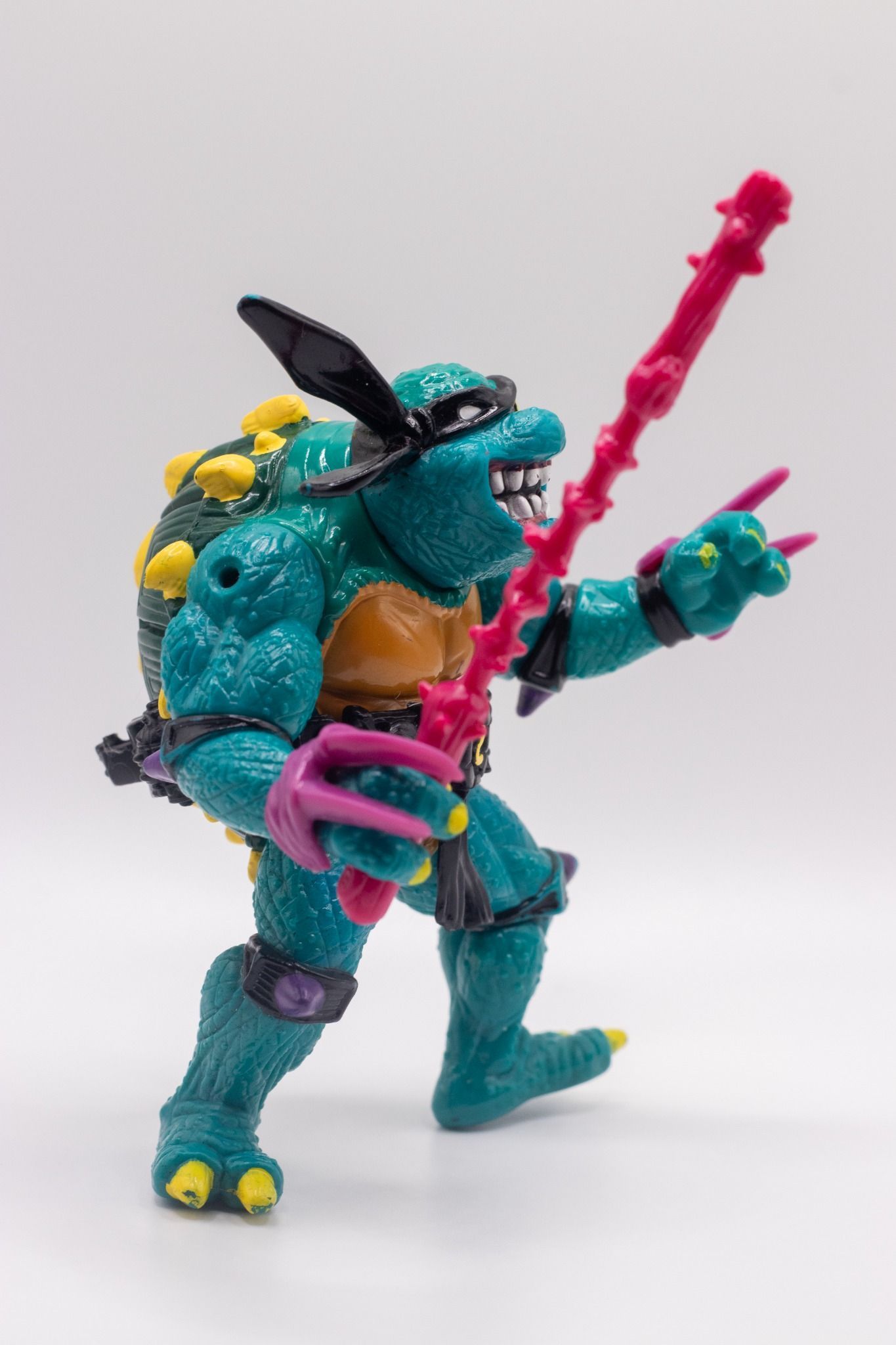 Right side profile of TMNT Slash action figure holding Nasty Nunchaku accessory