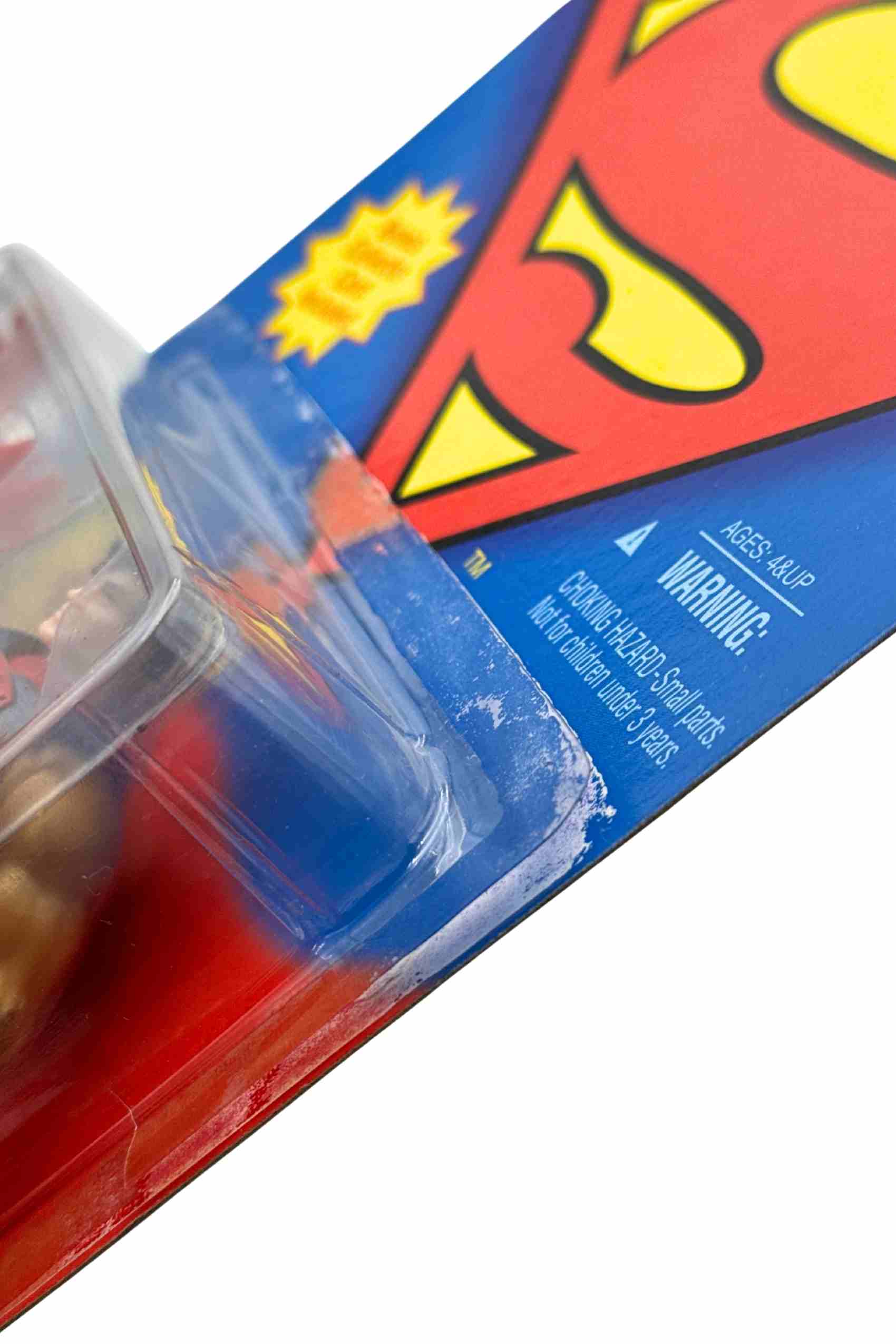Close-up shot of Solar Suit Superman action figure packaging showing lifting along top right blister seal