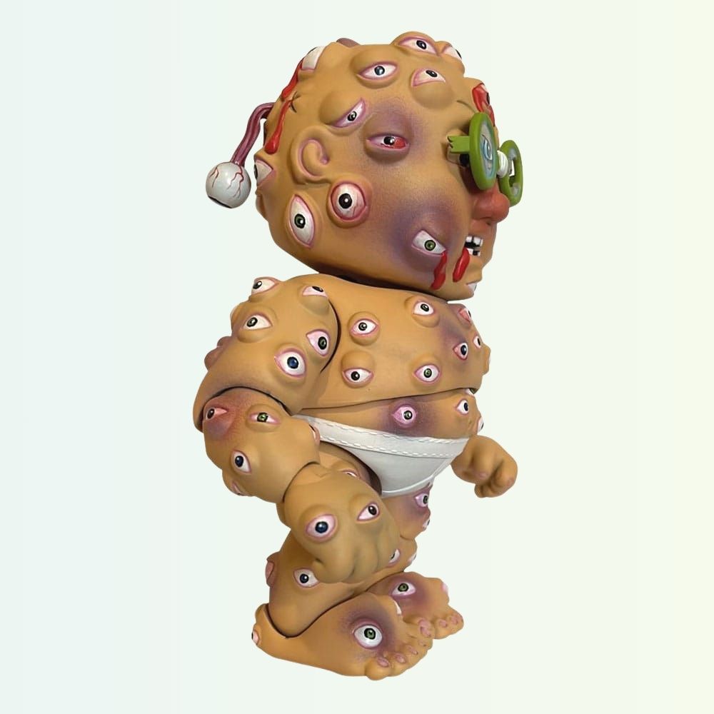 Side angle of Starin' Darren action figure with eyeballs all over and green glasses