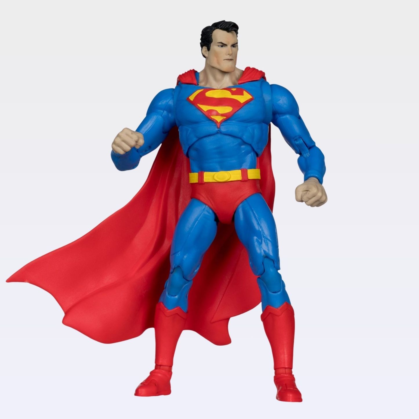 Front-angle shot of Superman Hush action figure with bright blue suit, red cape flowing and fists raised