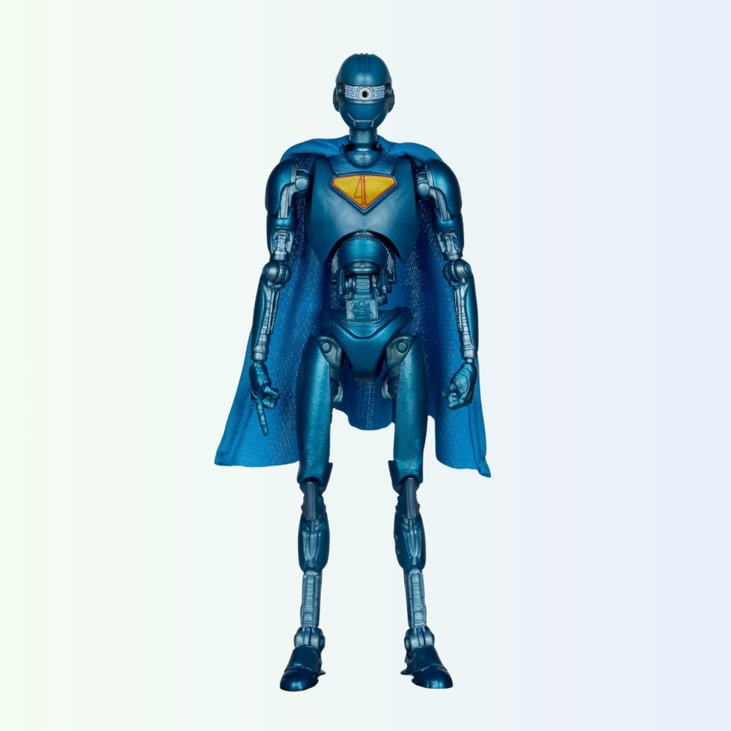 Face-on standing pose of Superman Robot action figure, arms relaxed and cape draped evenly