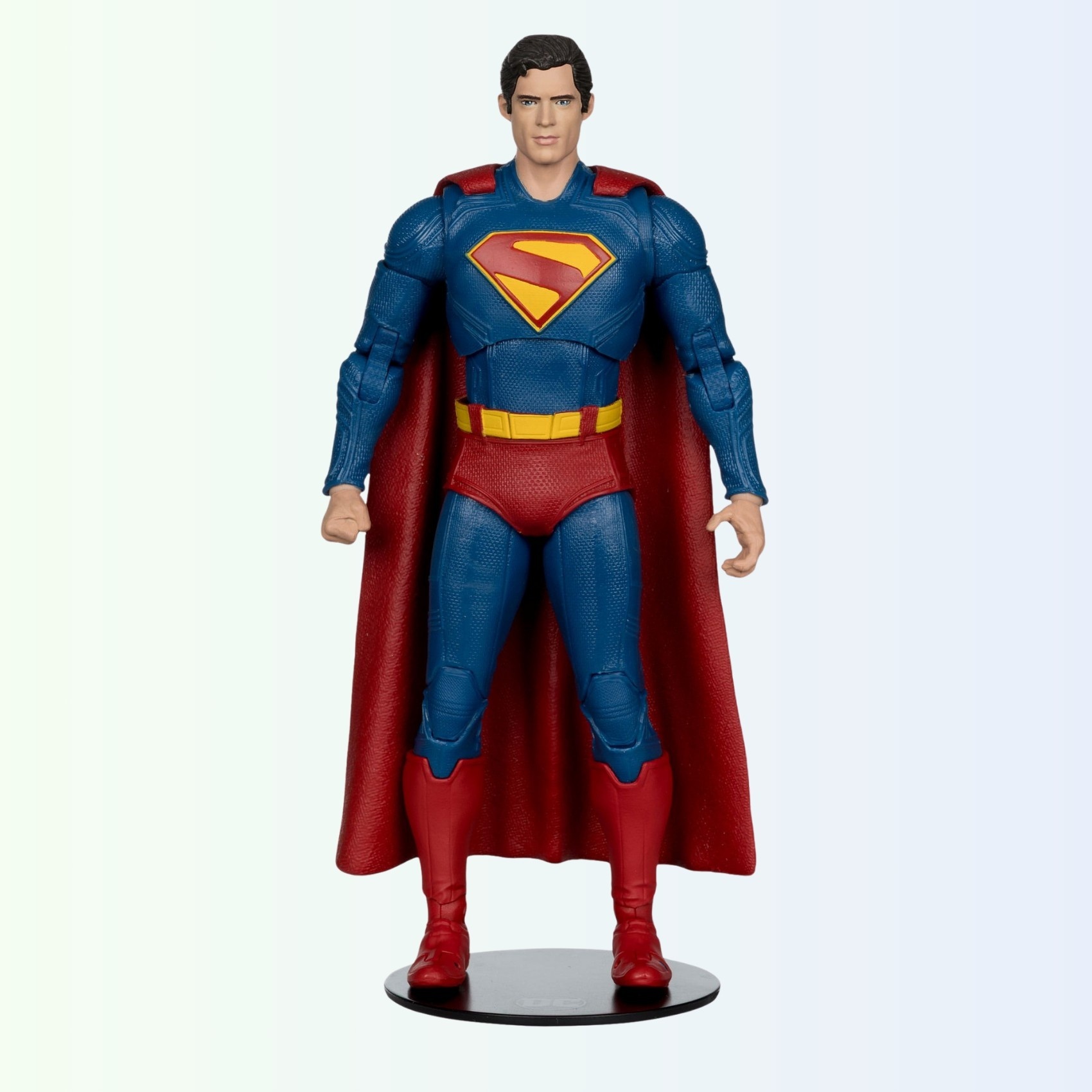 Straight-on standing pose of Superman action figure on round base