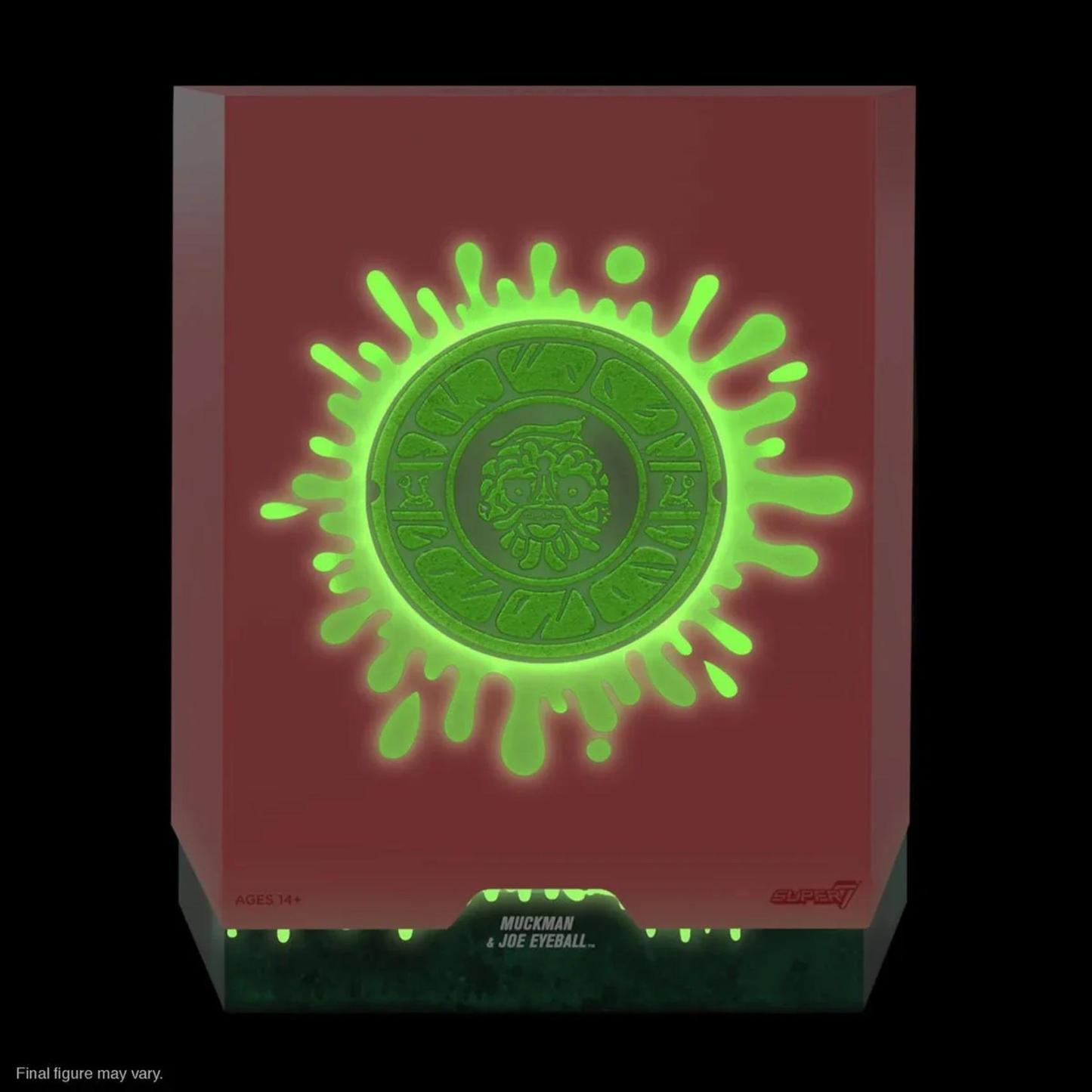 Front slipcase of Muckman and Joe Eyeball action figure packaging glowing in the dark with sewer lid design