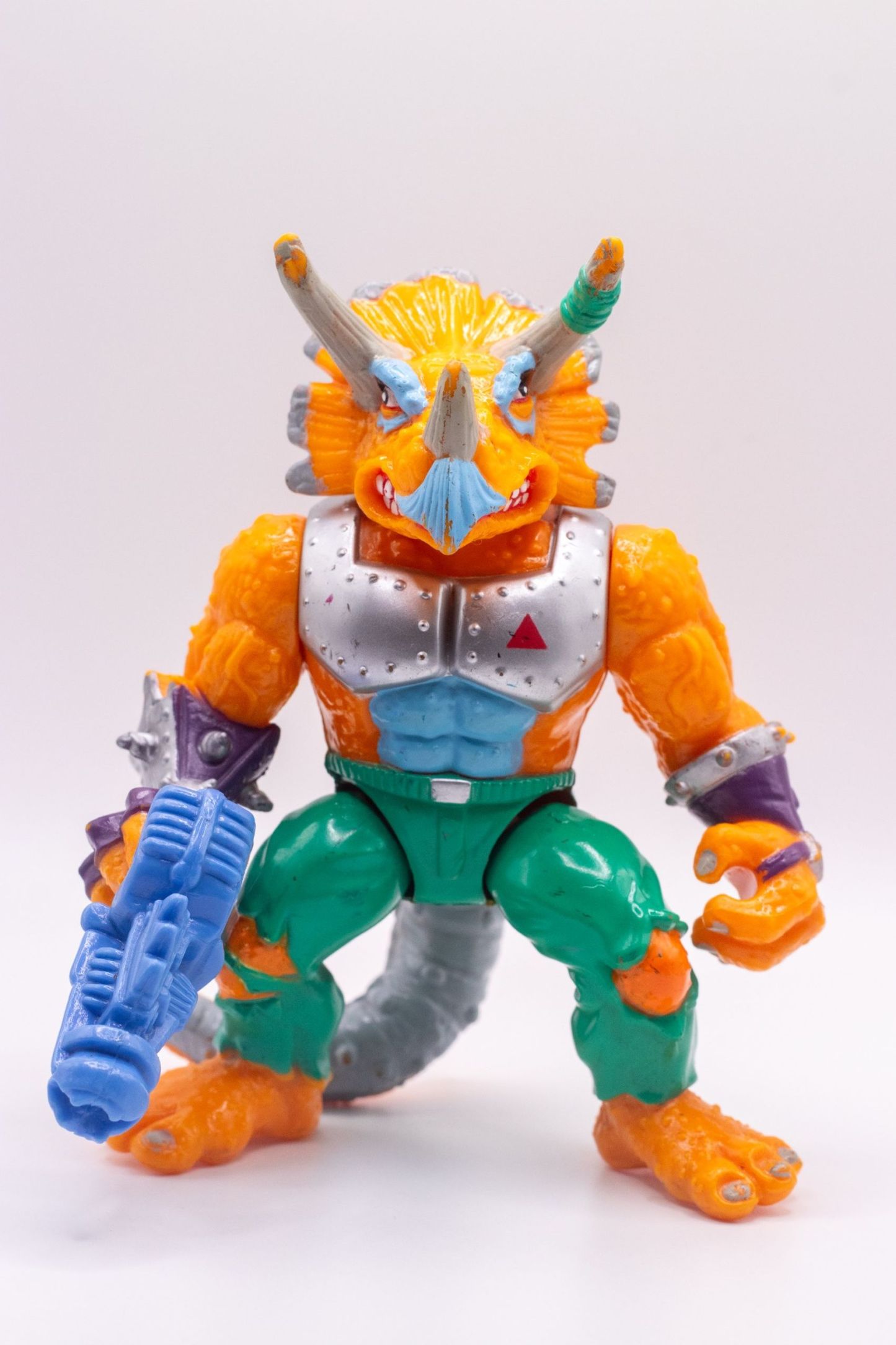 Front-facing shot of Triceraton action figure with chrome chest armour and raised Laser Phaser