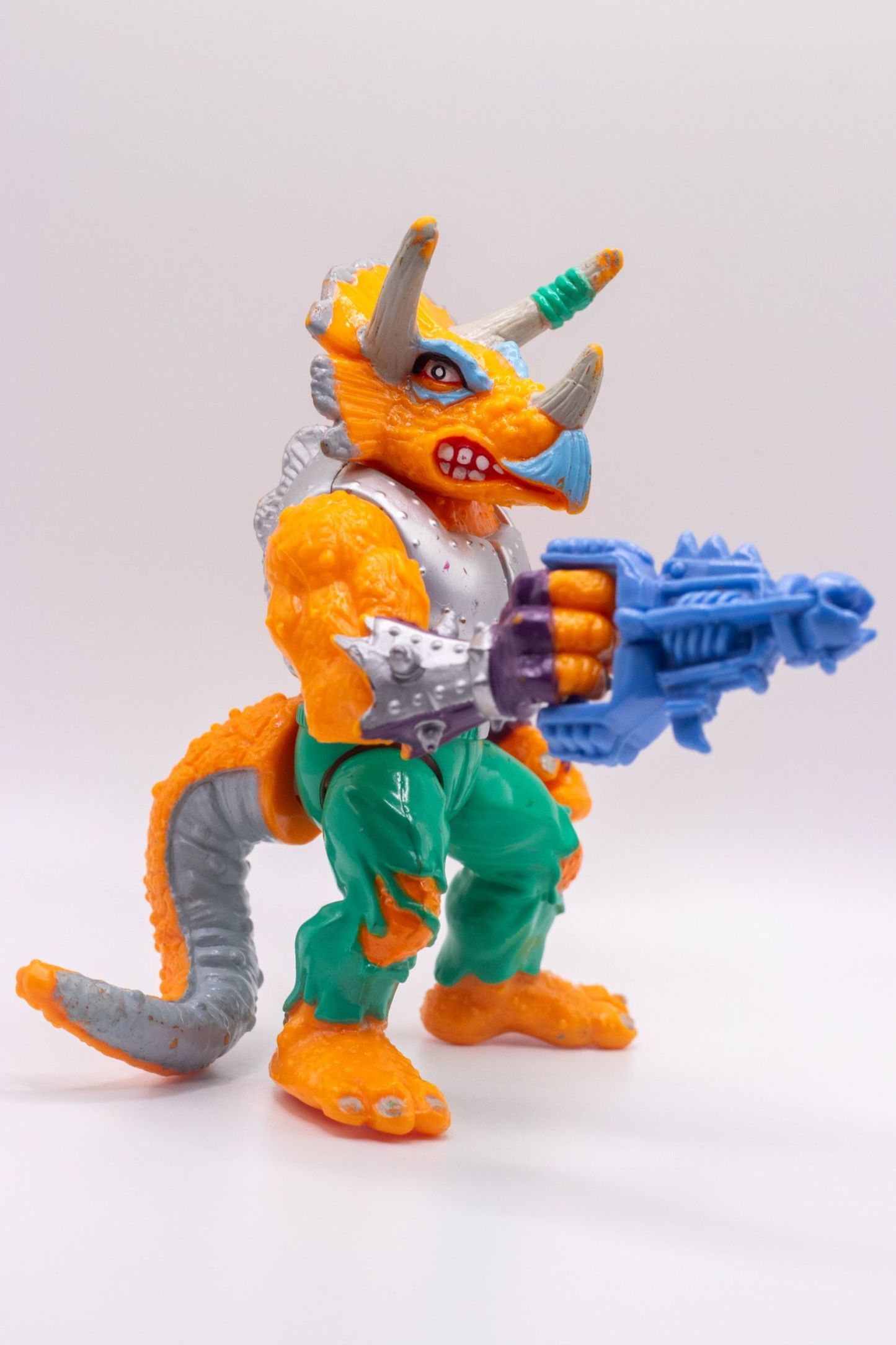 Right angle shot of Triceraton action figure with snarling expression and Laser Phaser extended
