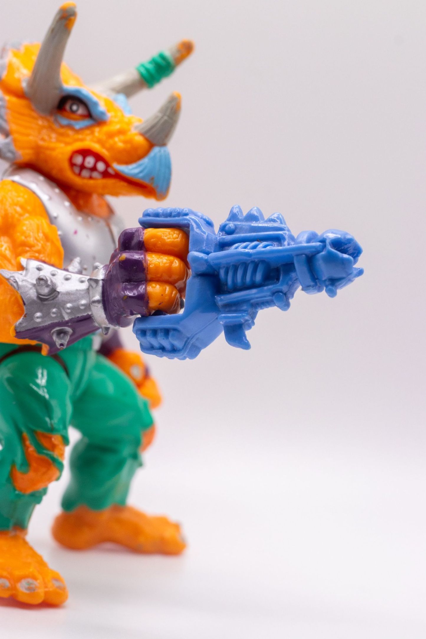 Close-up of Laser Phaser in Triceraton's hand, showing spiked gauntlet and weapon detail