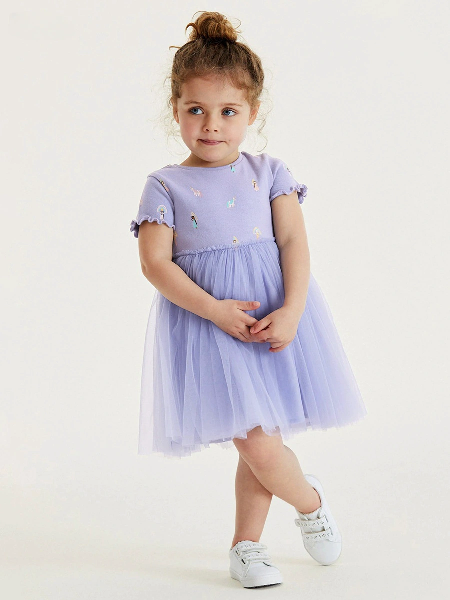 Toddler girl wearing a cartoon printed tulle princess dress by Little Maven