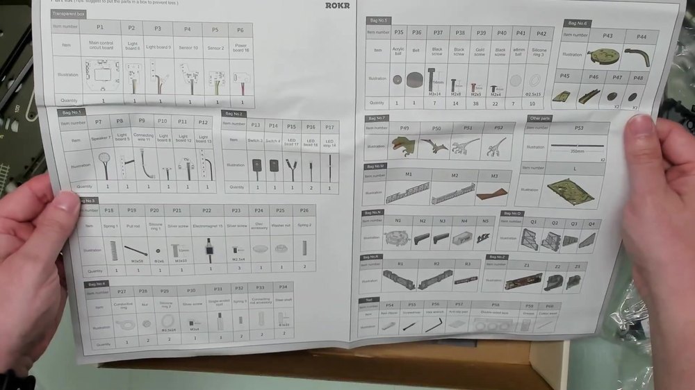 Dinosaur Lab Pinball parts list sheet held up for checking kit contents