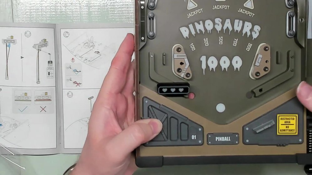 Dinosaur Lab playfield top with flippers and 1000-point targets installed