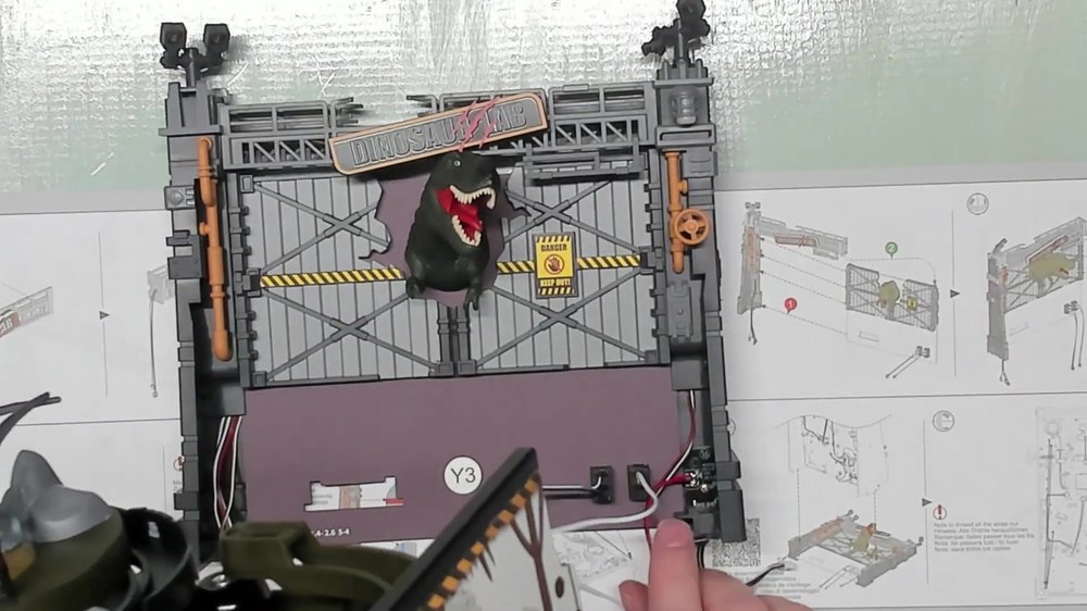 Assembled Dinosaur Lab backboard with T-rex figure and caution signage