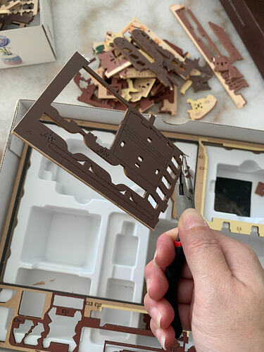 Using pliers to remove leftover wooden pieces safely