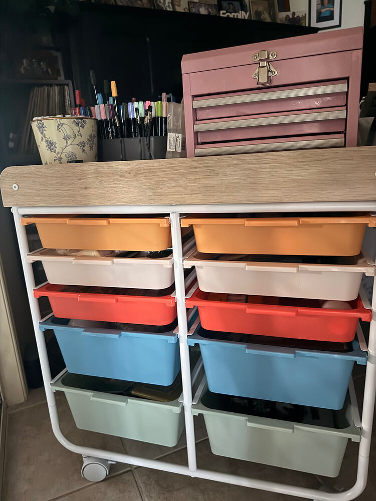 Craft trolley with colorful storage drawers, marker holders, and a pink toolbox on top