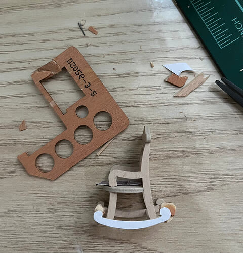 A paper stencil glued to rebuilt wood before sanding