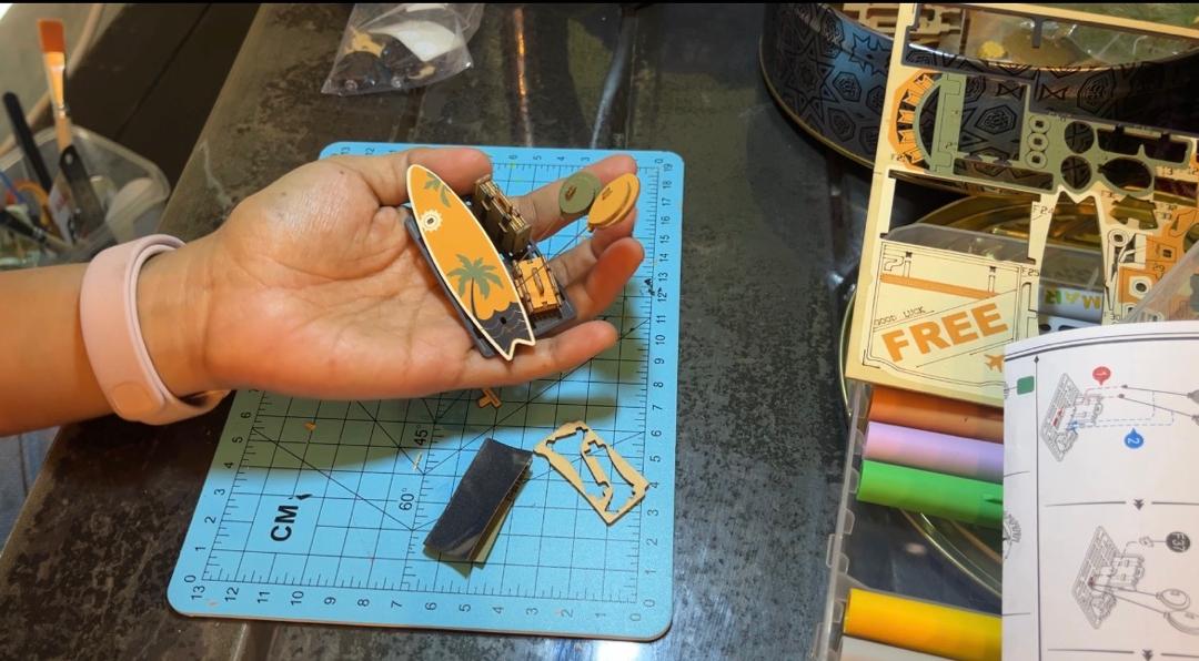 Aiffah holding the Road Tripper surfboard mechanism during assembly