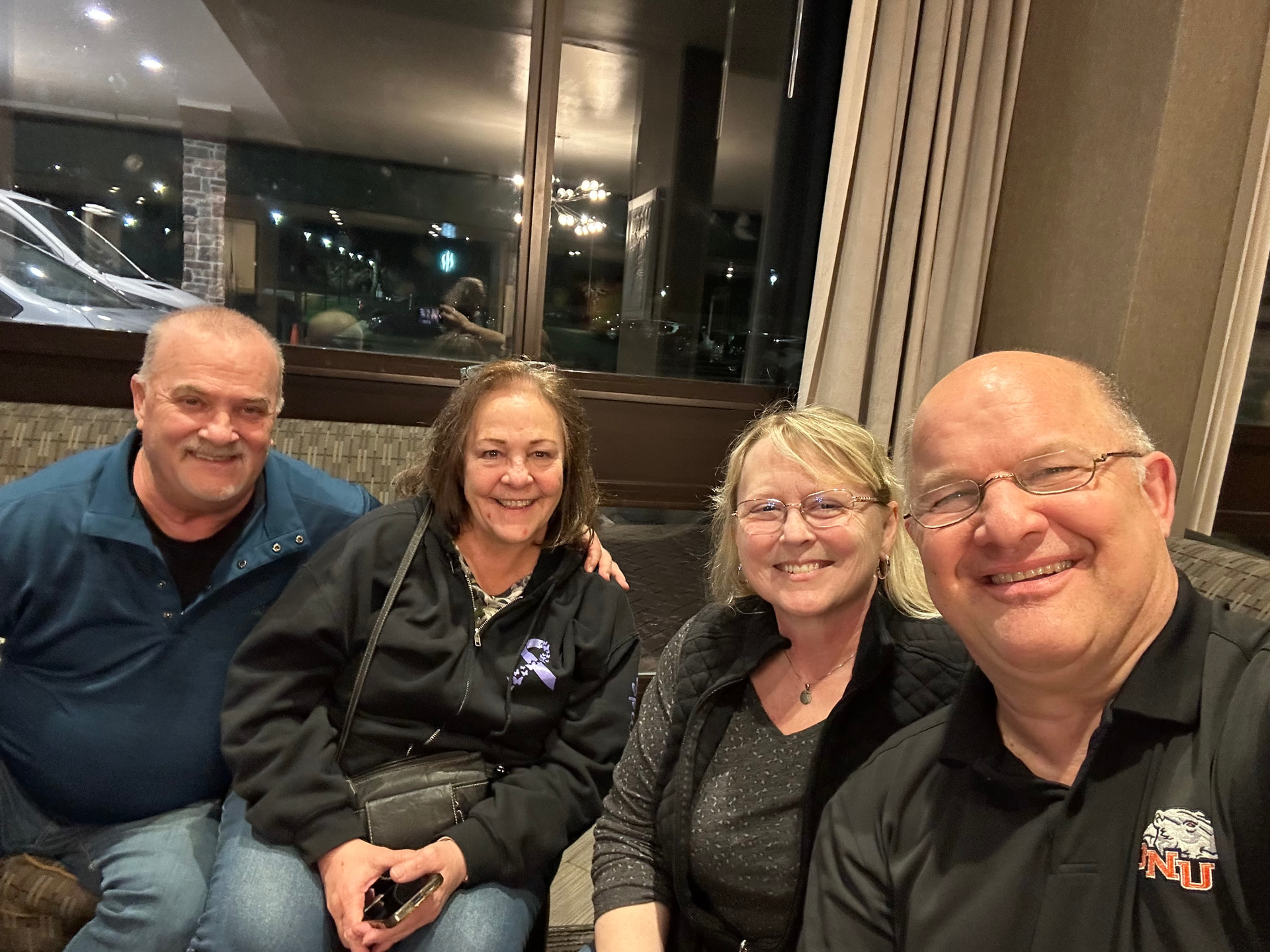 Tina and Jeanne smiling with their husbands after meeting through the Robotime community