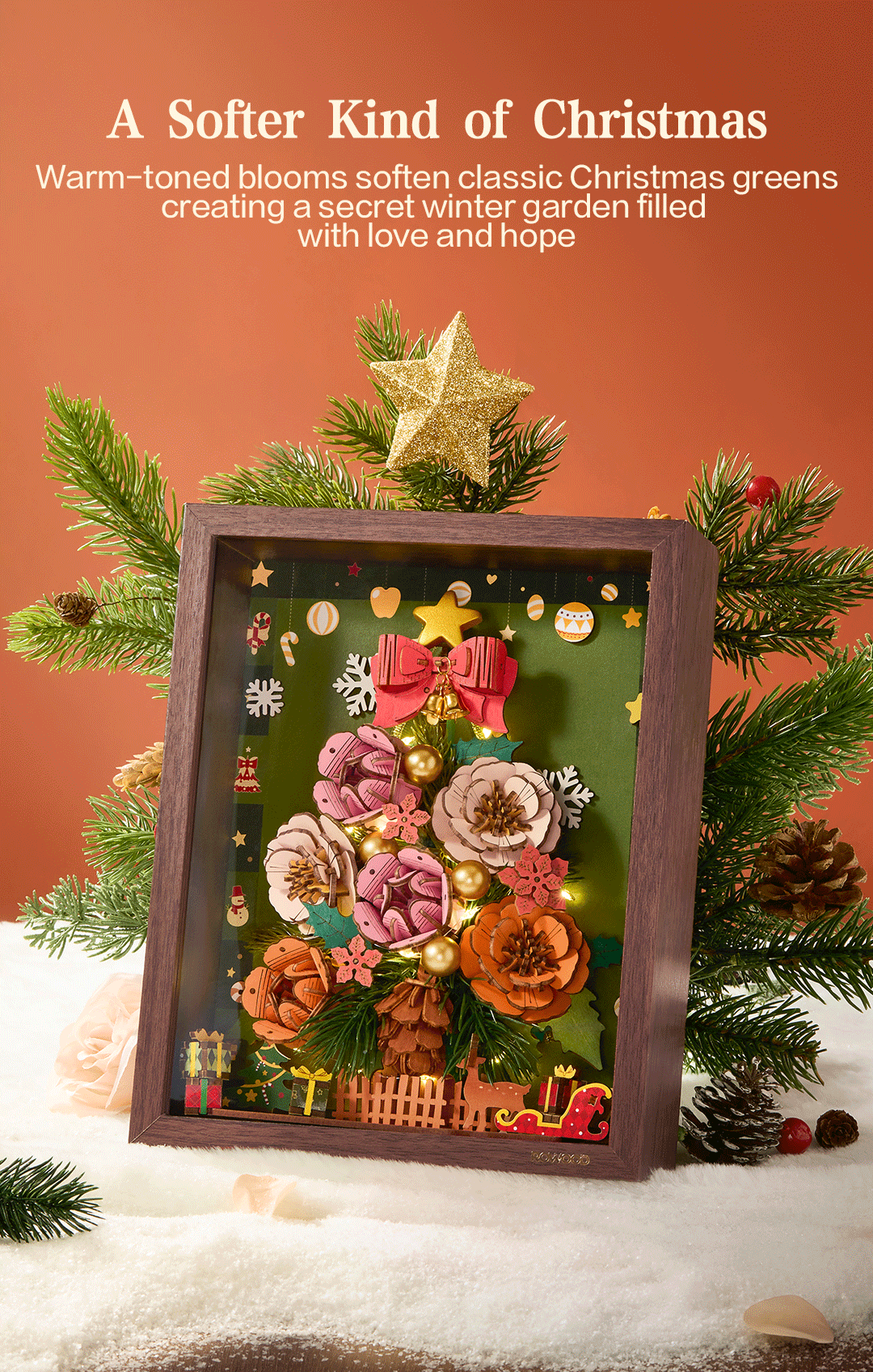 Warm-toned blooms and Christmas greenery in the illuminated frame