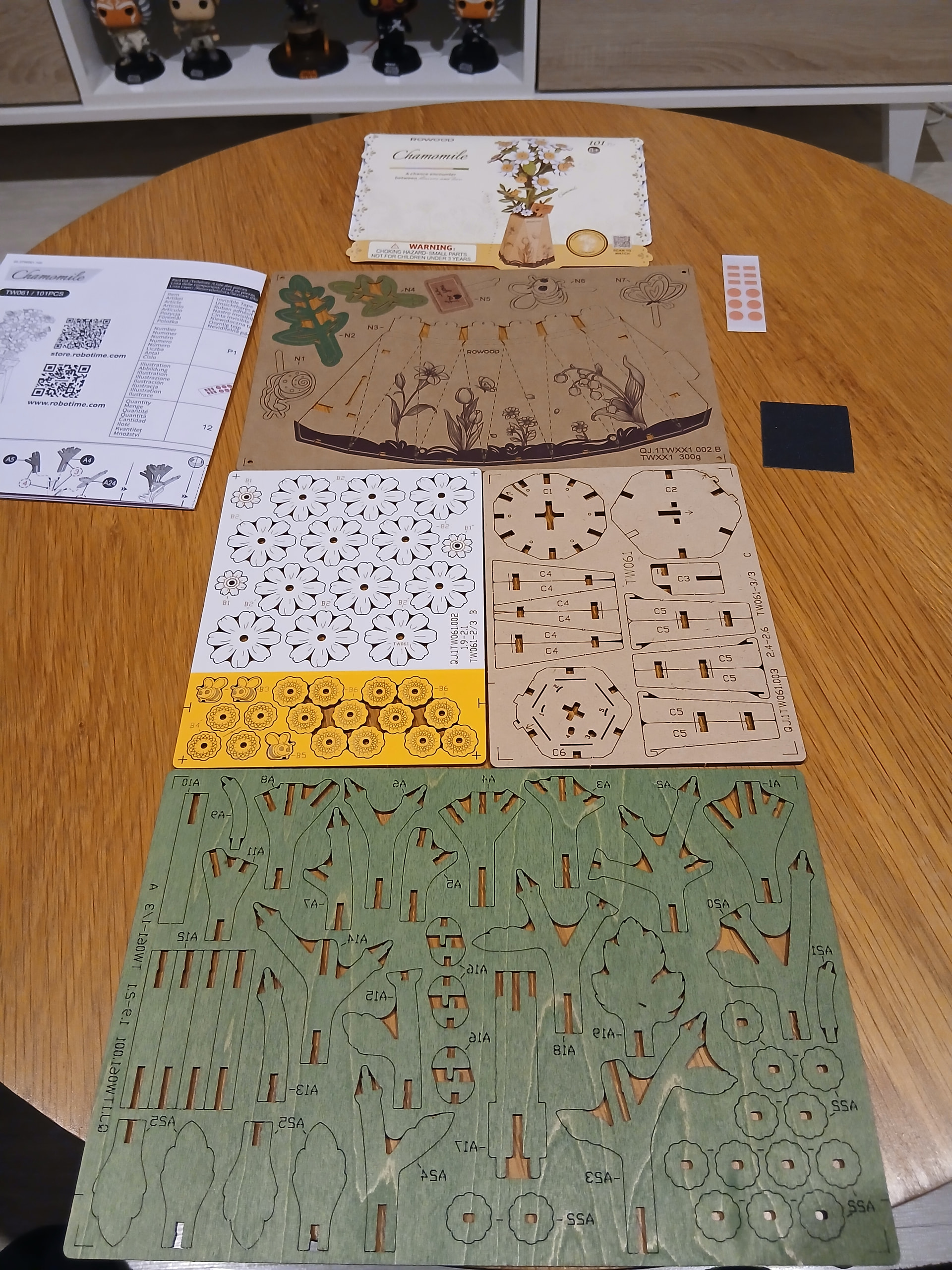 Rowood Chamomile wooden puzzle sheets, instructions, and accessories laid out before assembly