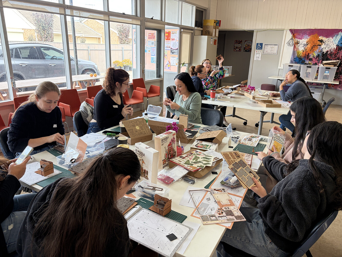 Queenstown meetup participants assembling DIY kits together around a table