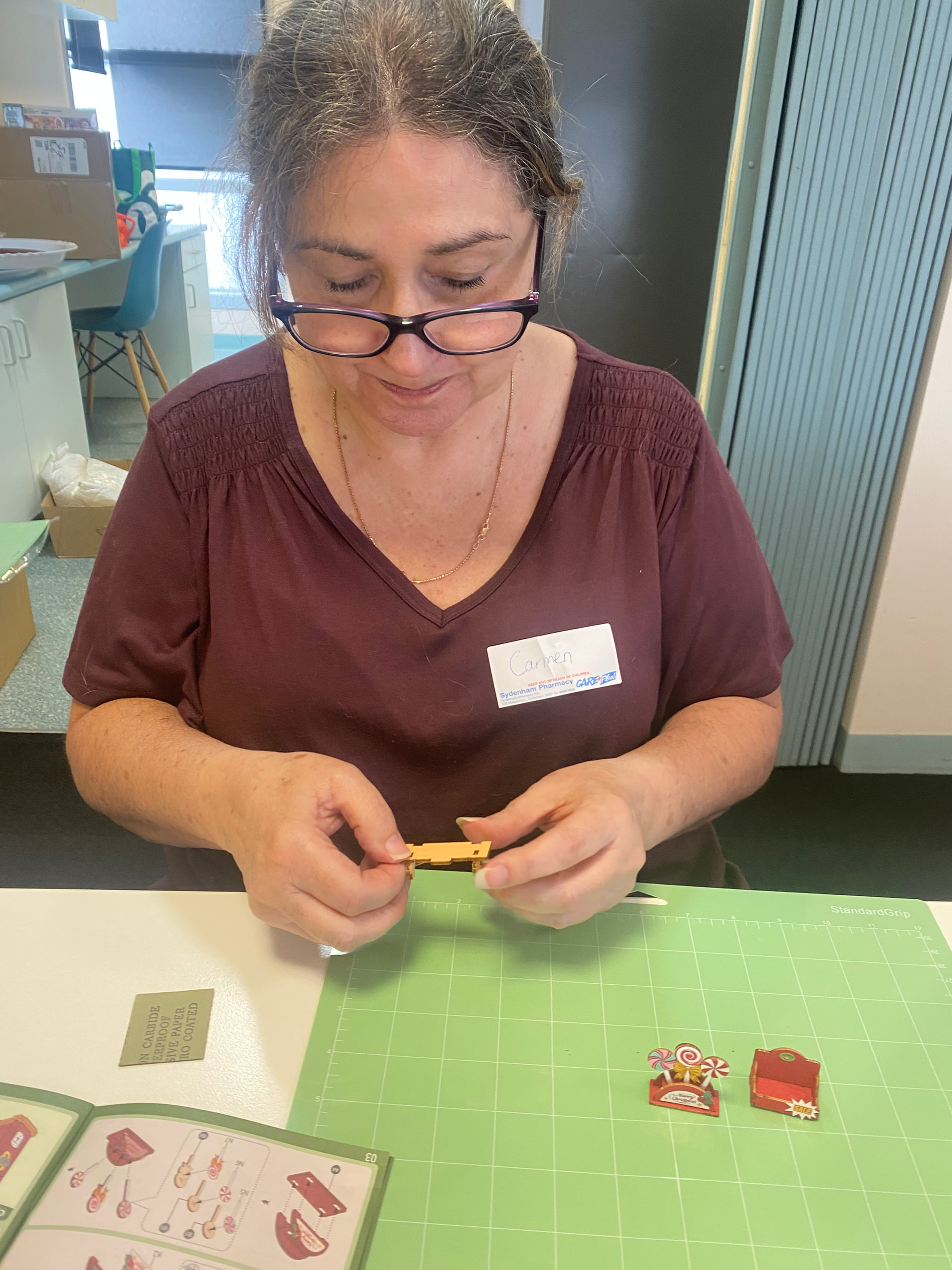 Carmie assembling small parts for her first Christmas miniature kit