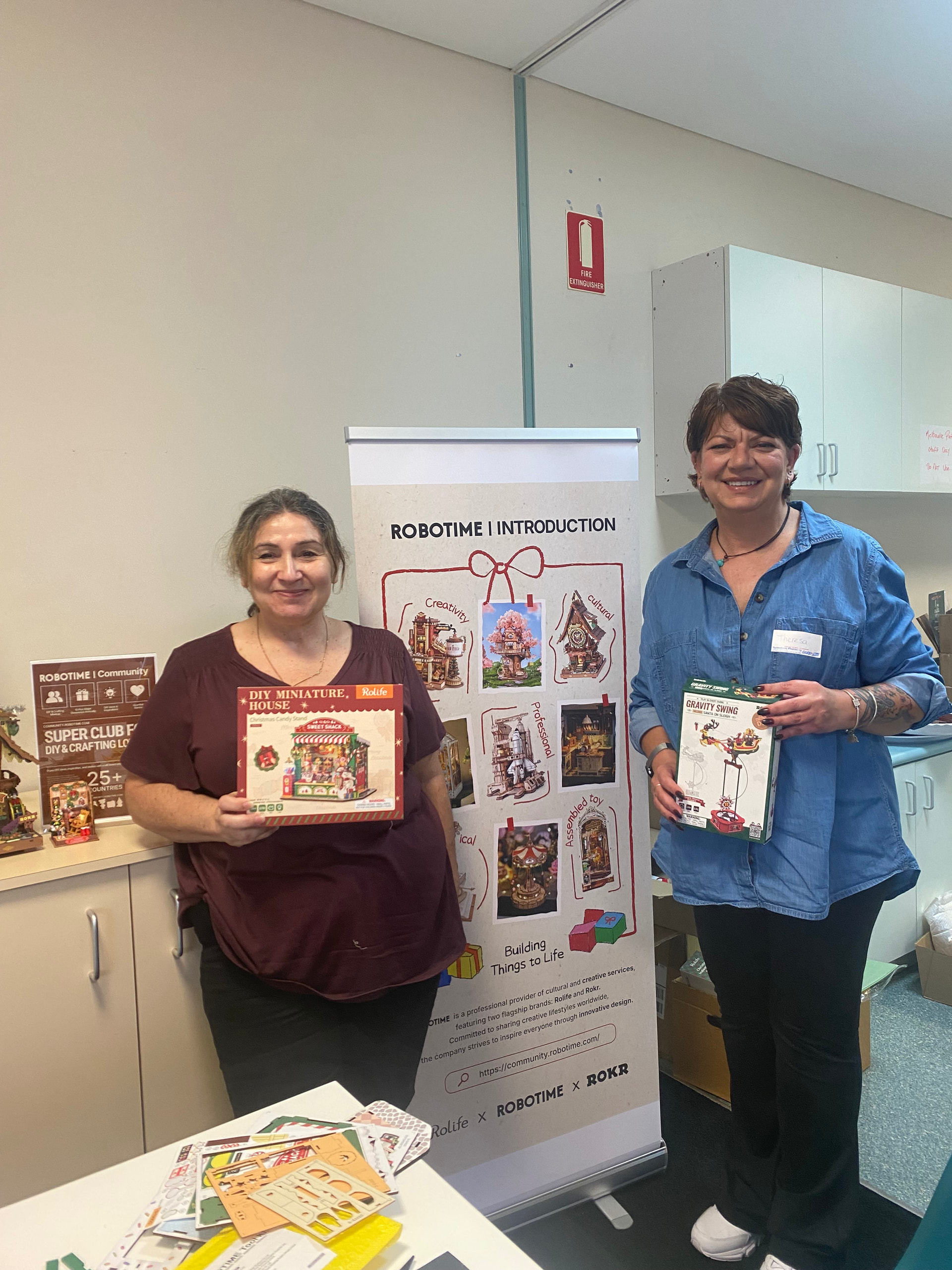 Carmie and Terii holding their chosen Christmas-themed DIY kits at the Melbourne meetup