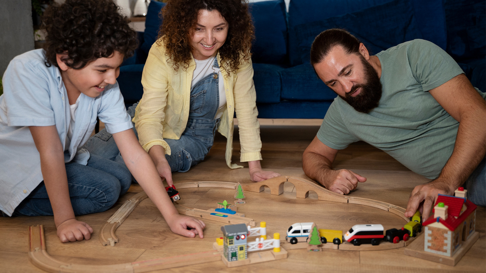 A child and parents exploring a hands-on STEM activity together