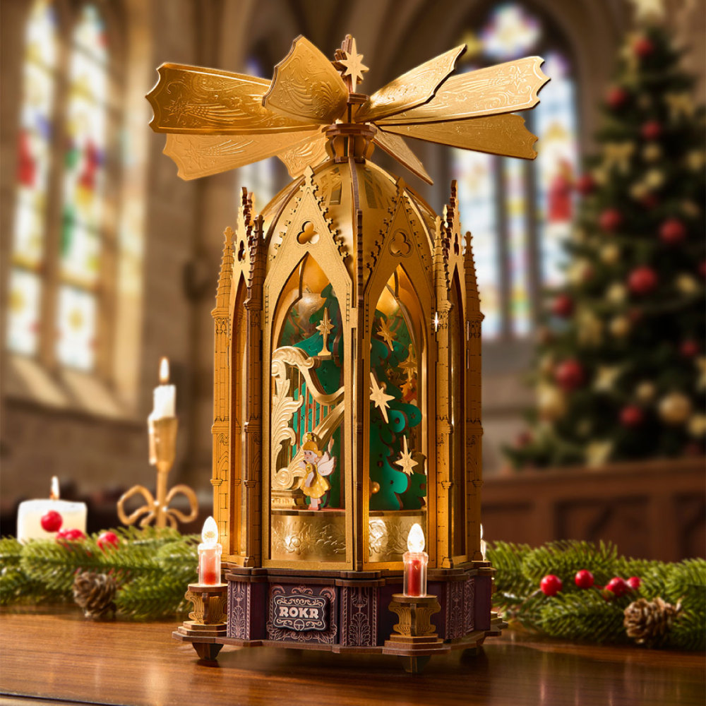 Pointed arches and gold details around the illuminated AMB01 Christmas scene