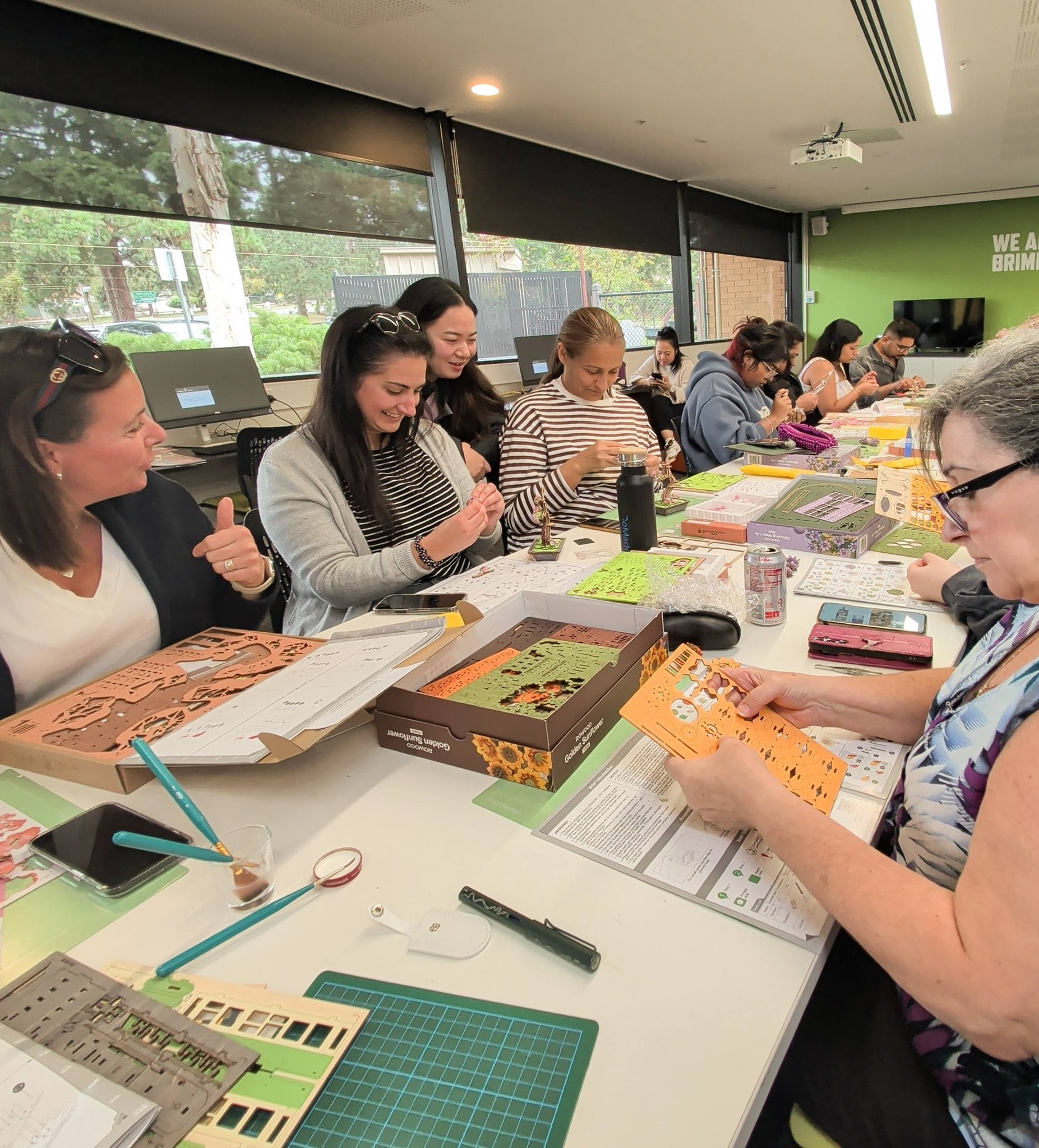 Melbourne meetup participants building miniature kits together around a library table