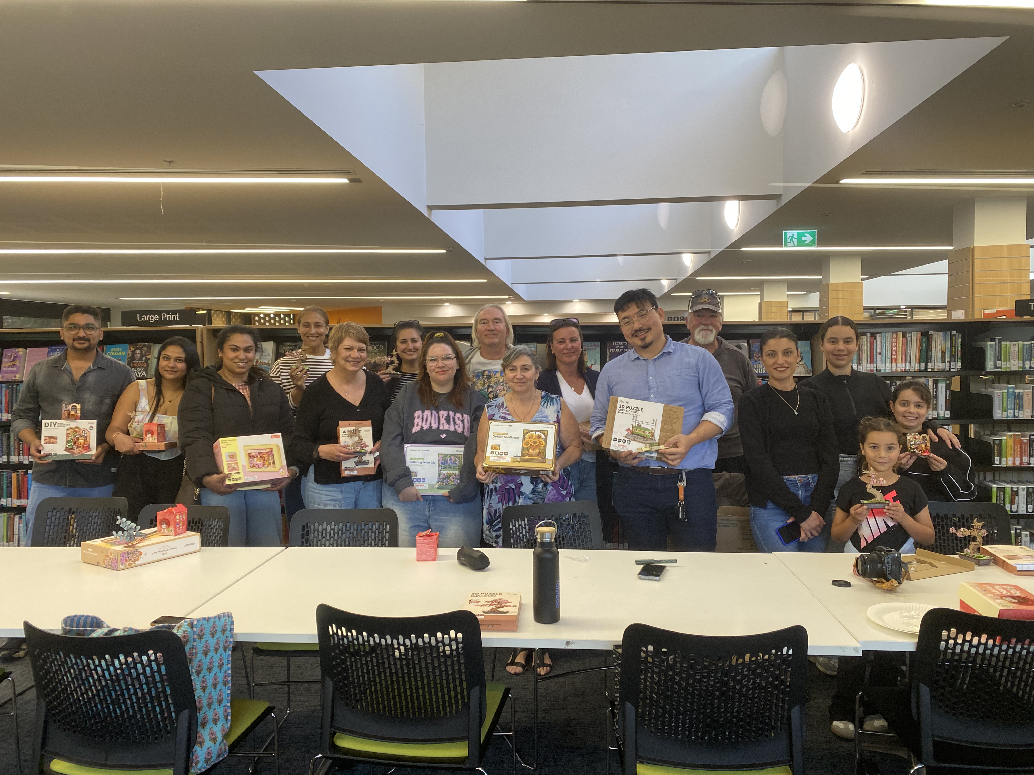 Participants holding their kits for a group photo at the second Robotime Melbourne meetup