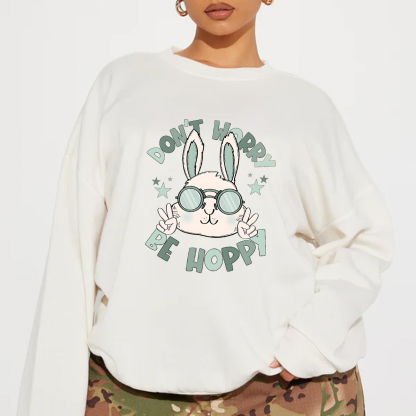 "Don'T Hoppy" Slogan And The Image Of A Rabbit Wearing Sunglasses, A Rabbit Holding Up Two Fingers And Making A "V" Sign, A Casual Sports Shirt, And A Crew Neck Sweatshirt.