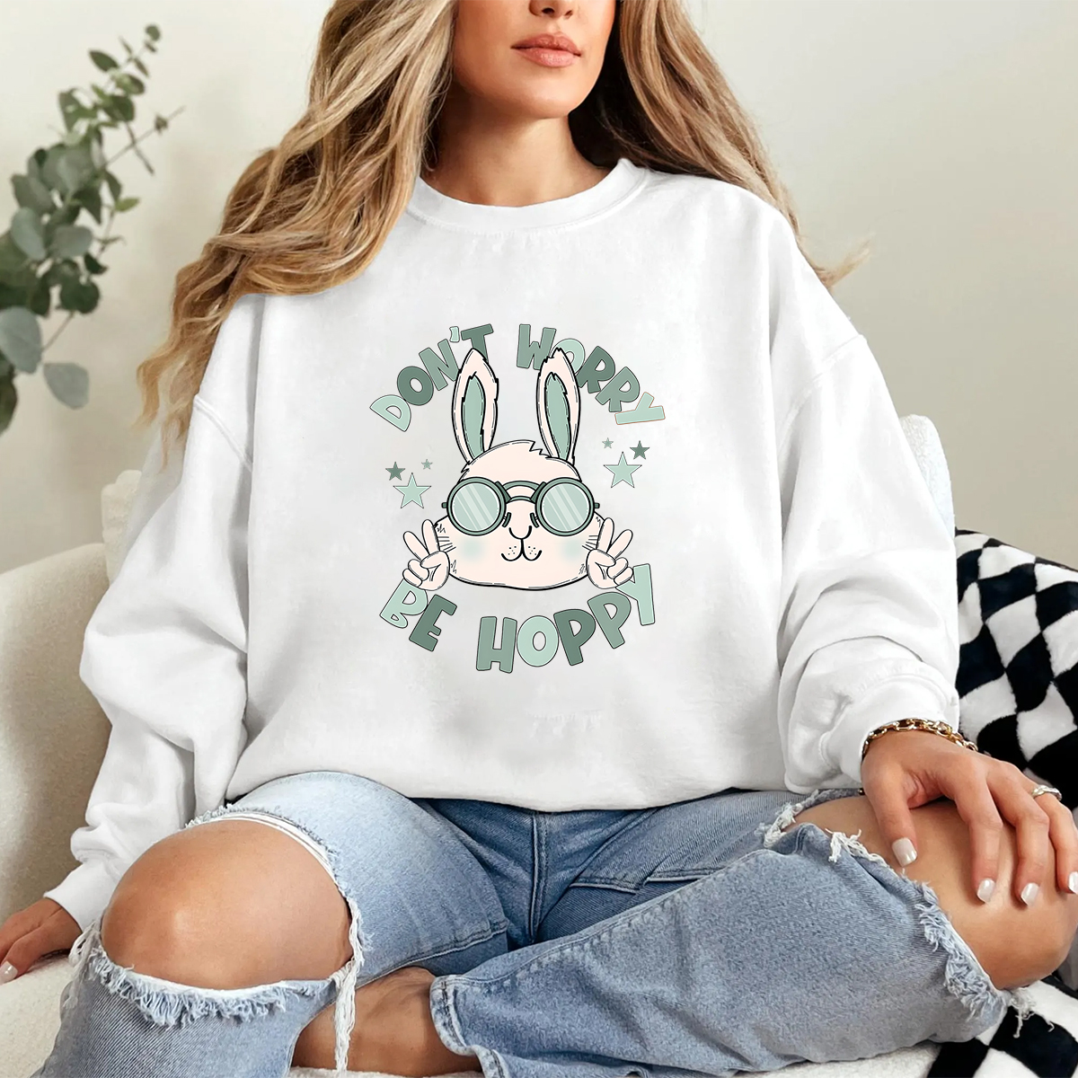 "Don'T Hoppy" Slogan And The Image Of A Rabbit Wearing Sunglasses, A Rabbit Holding Up Two Fingers And Making A "V" Sign, A Casual Sports Shirt, And A Crew Neck Sweatshirt.