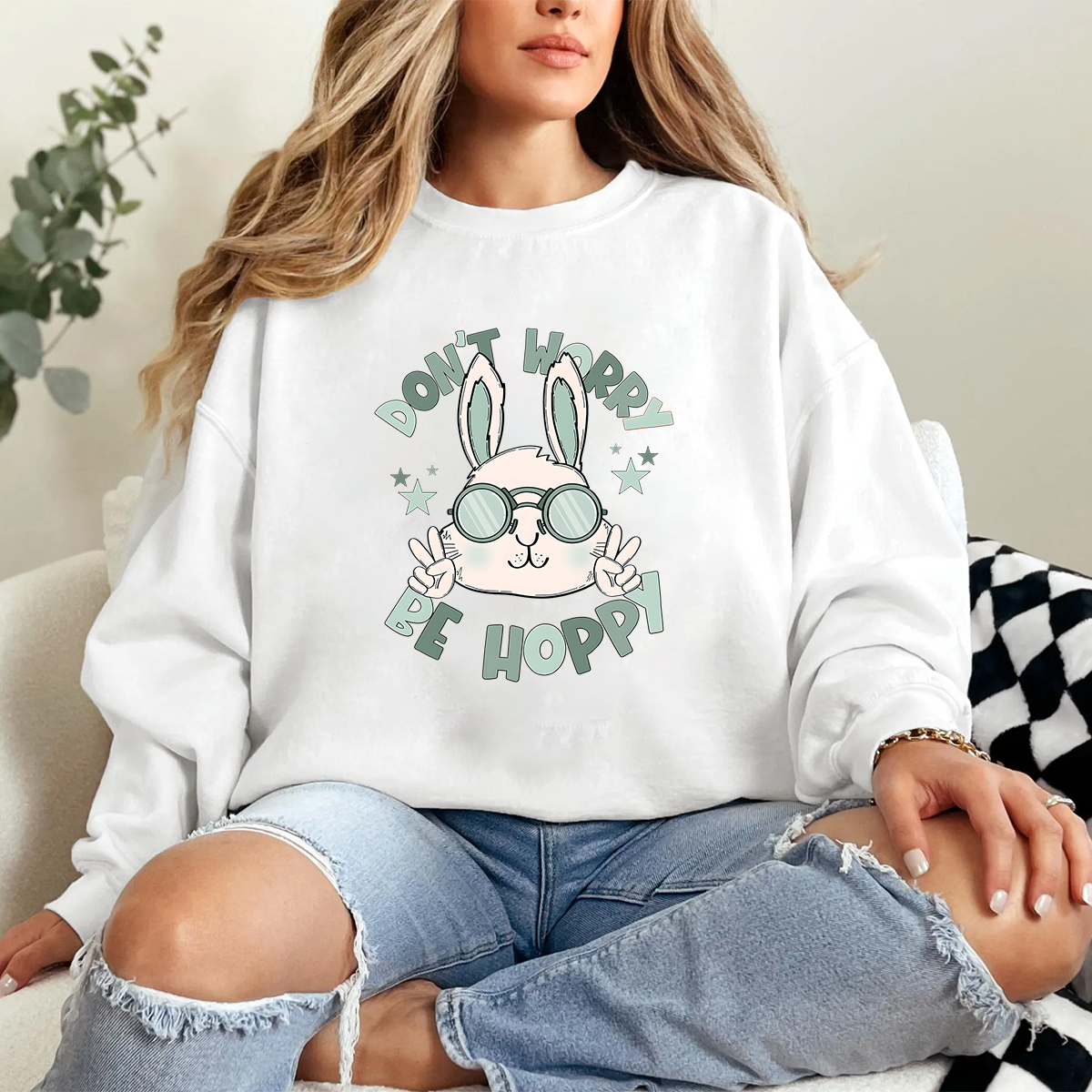 "Don'T Hoppy" Slogan And The Image Of A Rabbit Wearing Sunglasses, A Rabbit Holding Up Two Fingers And Making A "V" Sign, A Casual Sports Shirt, And A Crew Neck Sweatshirt.